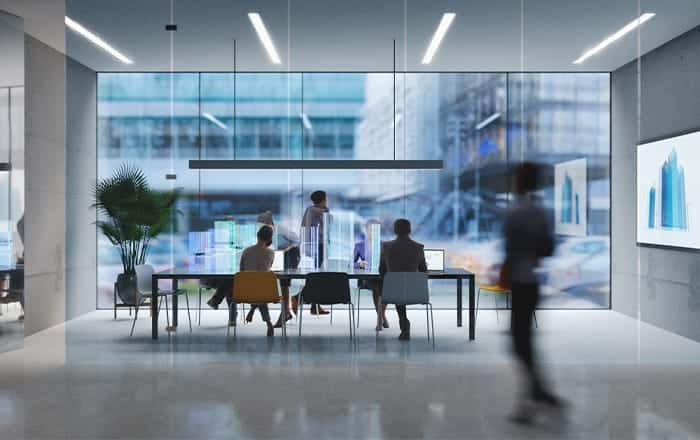 Modern office with CRE IT Consulting team at a conference table, blurred figure walking by.