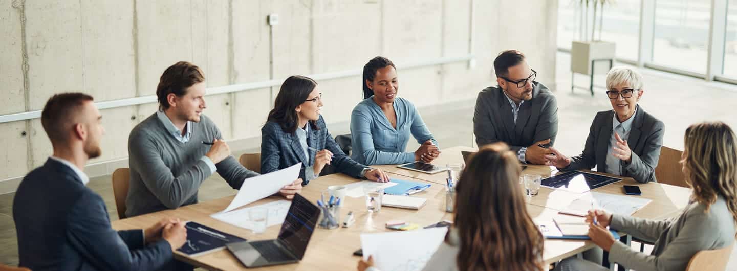 Large group of happy business colleagues communicating while working on a meeting in the office. Copy space.