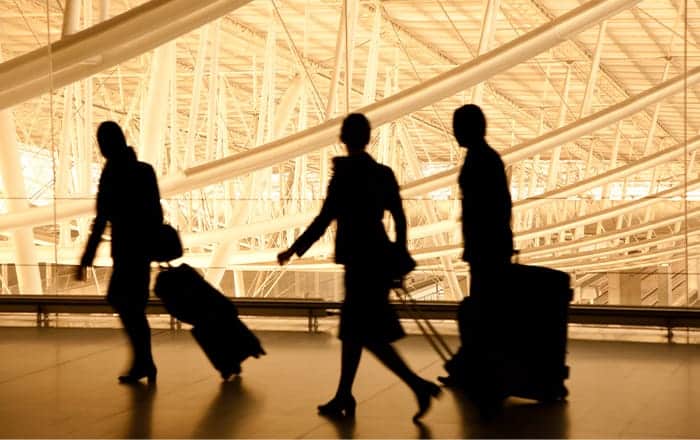 Silhouettes of travelers at an airport, inspired by AI-driven hyper-personalization strategies.