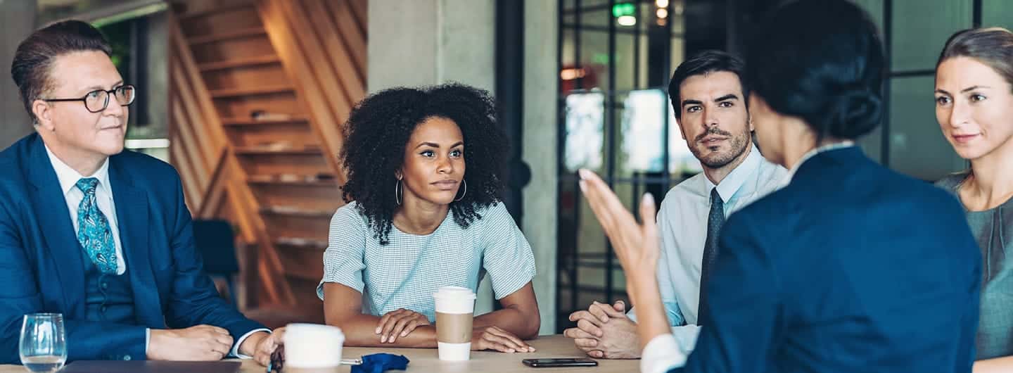 Multi-ethnic group of business persons discussing business