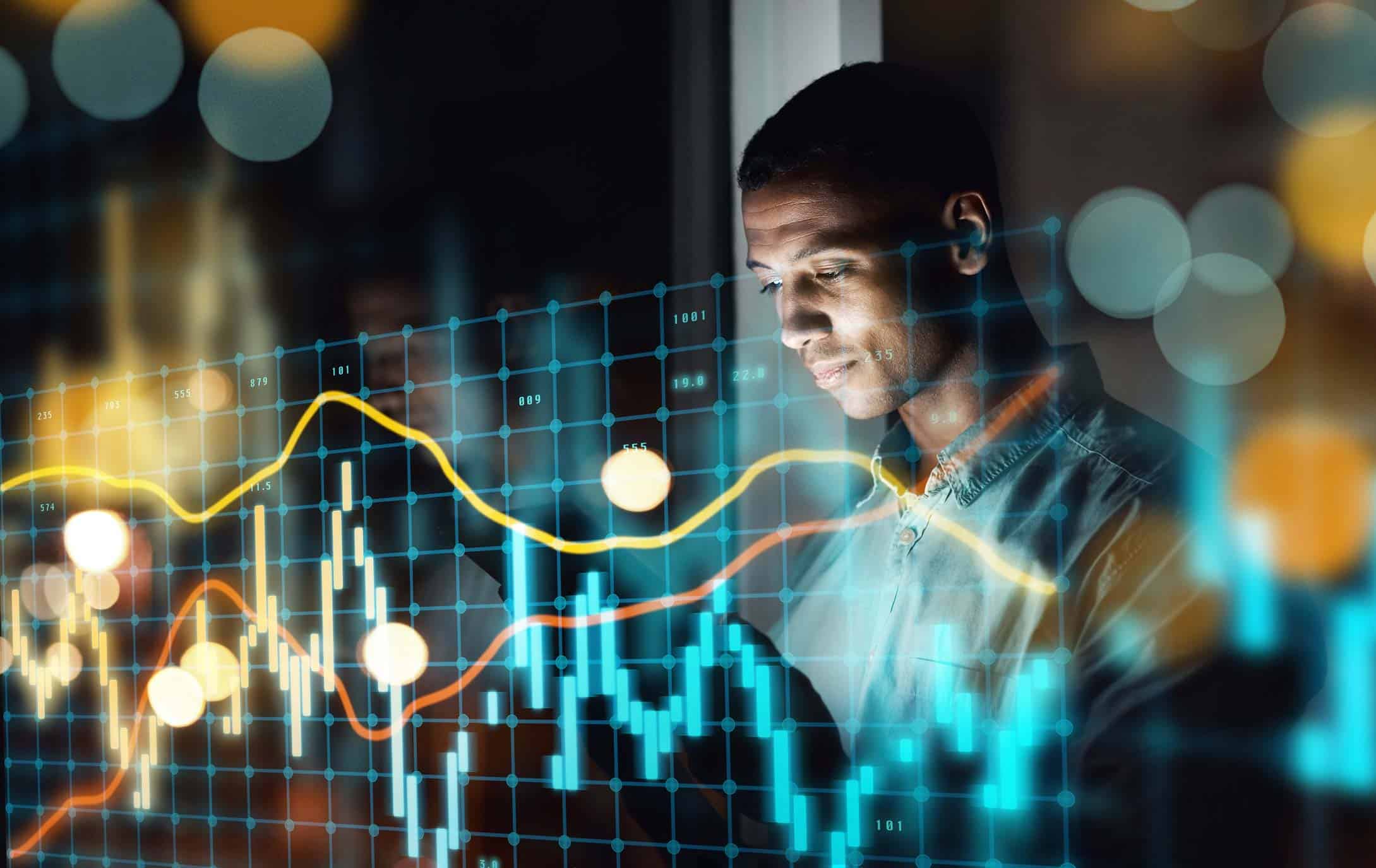 Man observes financial graphs, aided by financial services digital transformation consulting.