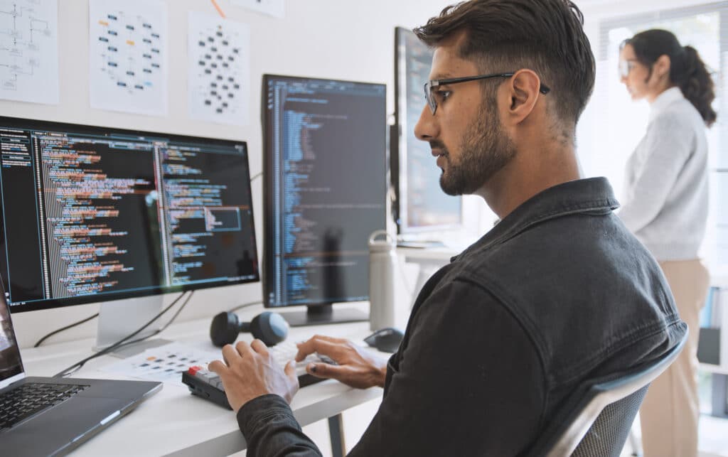 Man coding on computer representing RPO Consulting