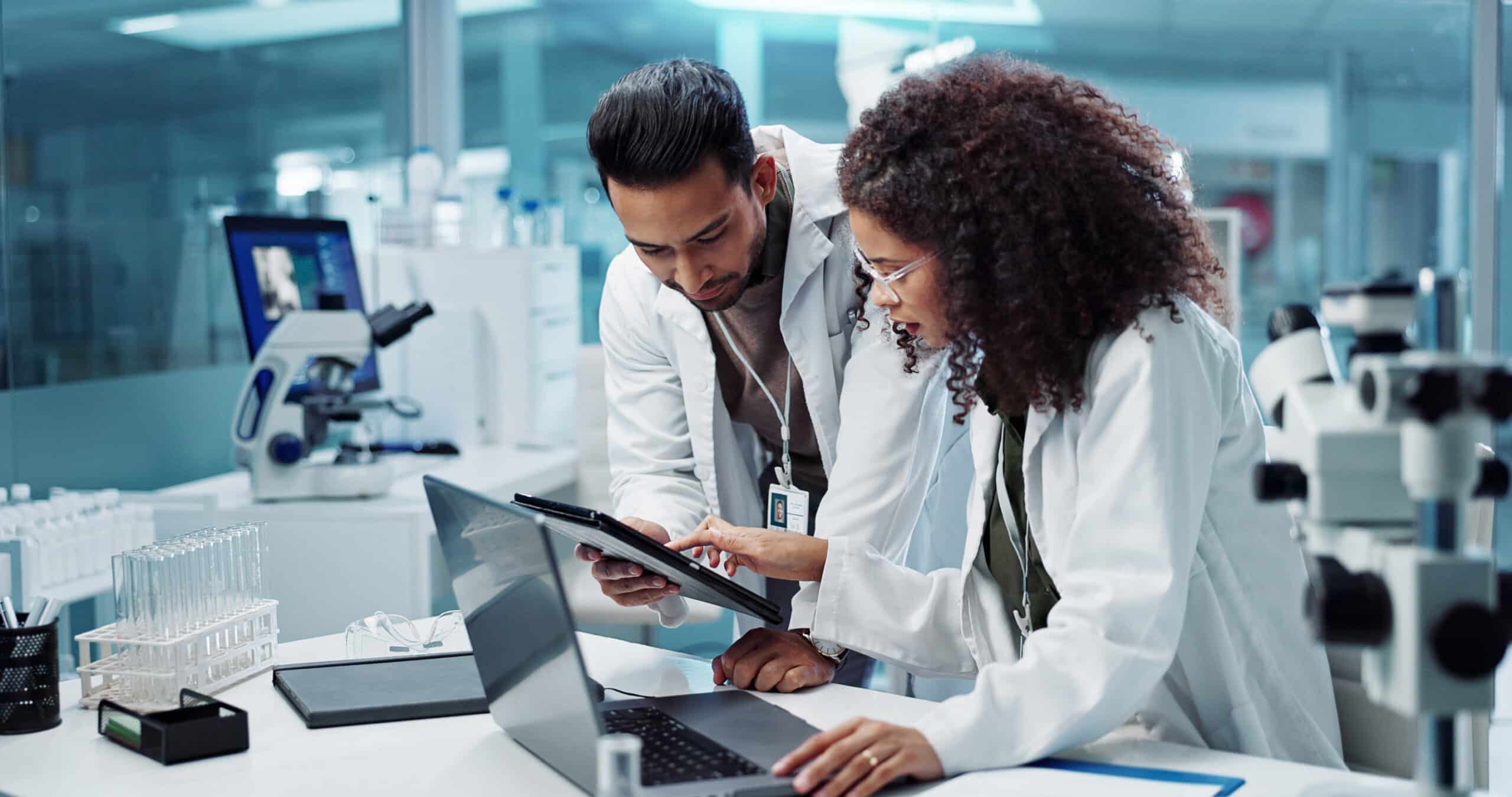 Two scientists review data in a lab, showcasing Healthcare & Life Science Strategy consulting.