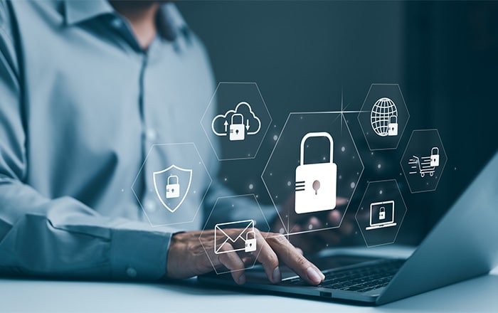 Person on laptop with cybersecurity consulting services icons like padlocks and cloud symbols.