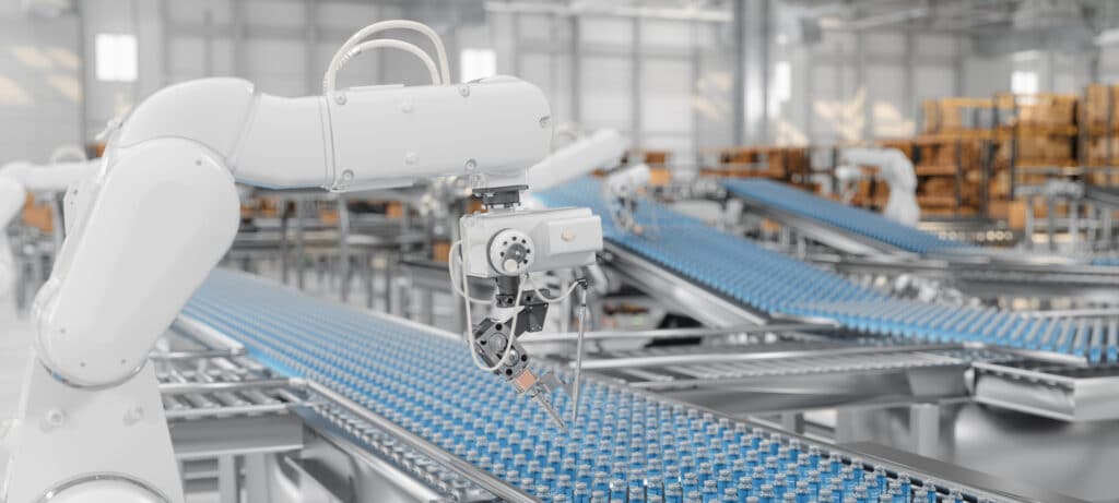 Robotic arm sorting bottles on a conveyor belt in a modern factory setting.