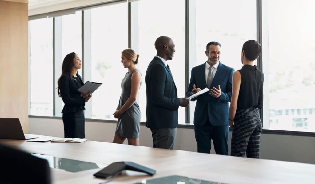 Business professionals collaborating at a modern office table with charts and documents