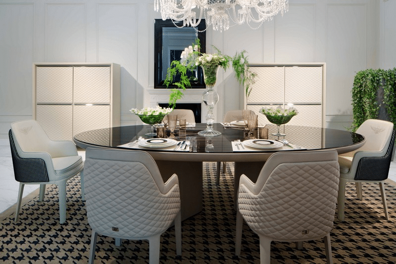 The dining table and quilted chairs showcase exquisite craftsmanship and materials.