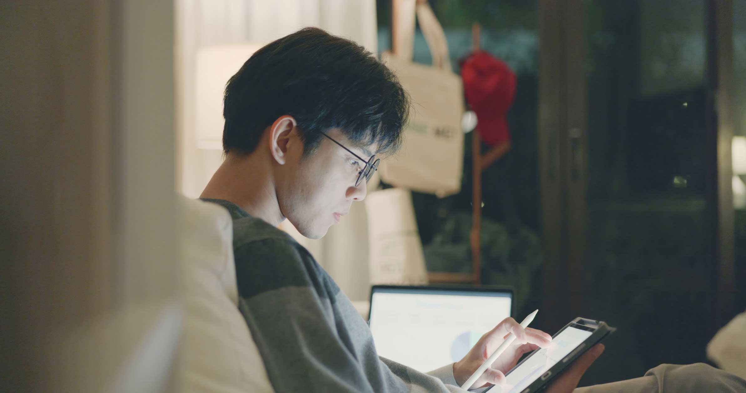 A person with glasses uses a tablet, ideal for a mobile device management consulting firm.