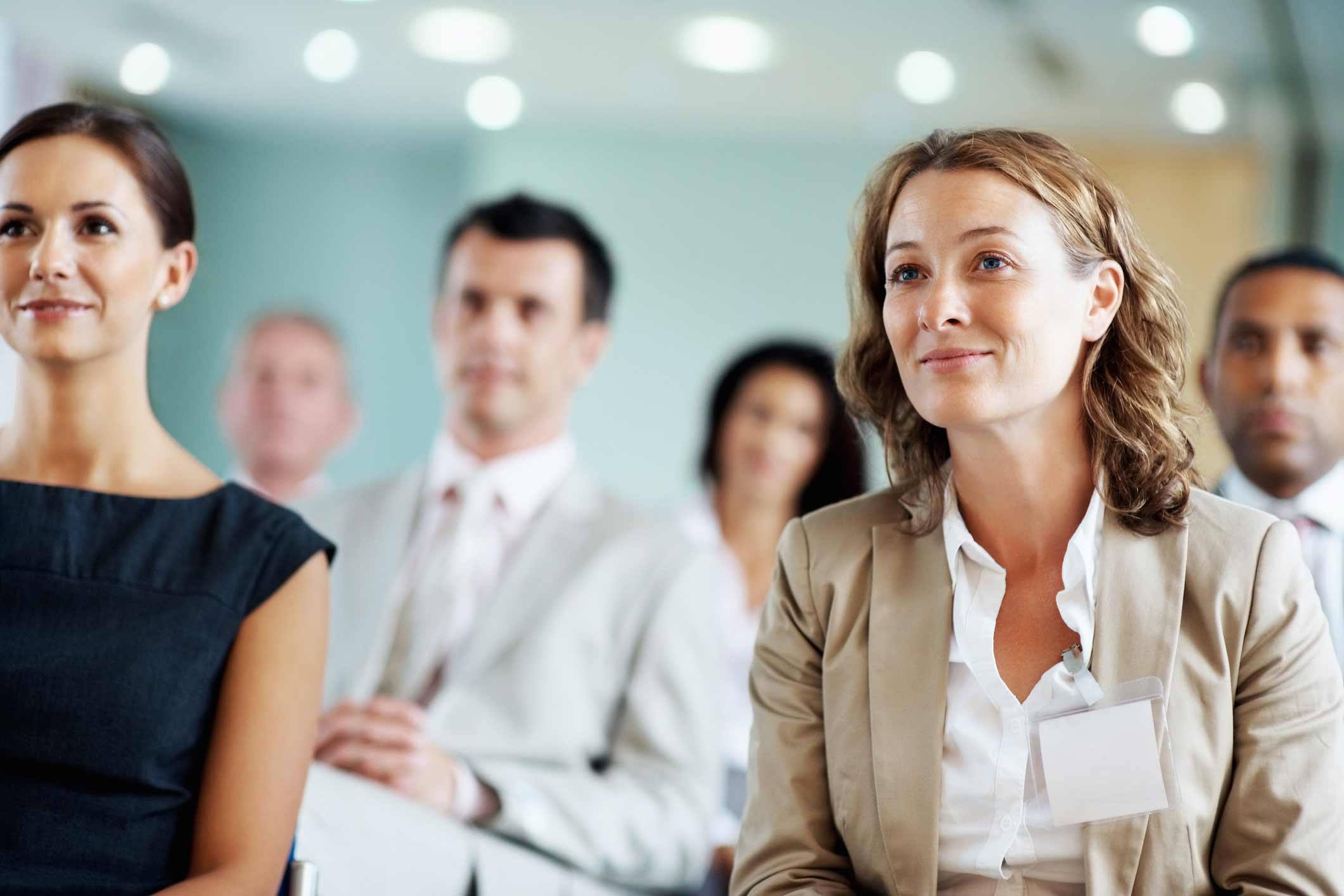 Business professionals attentively listening at a Law Firm CRM Adoption seminar.