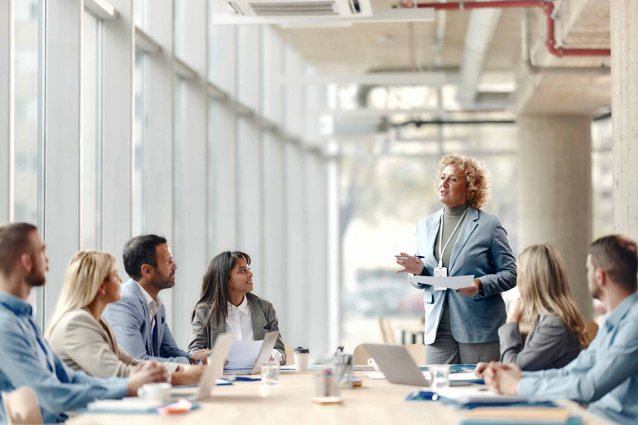 Woman presenting Change Management for Document Management in a modern office meeting room.