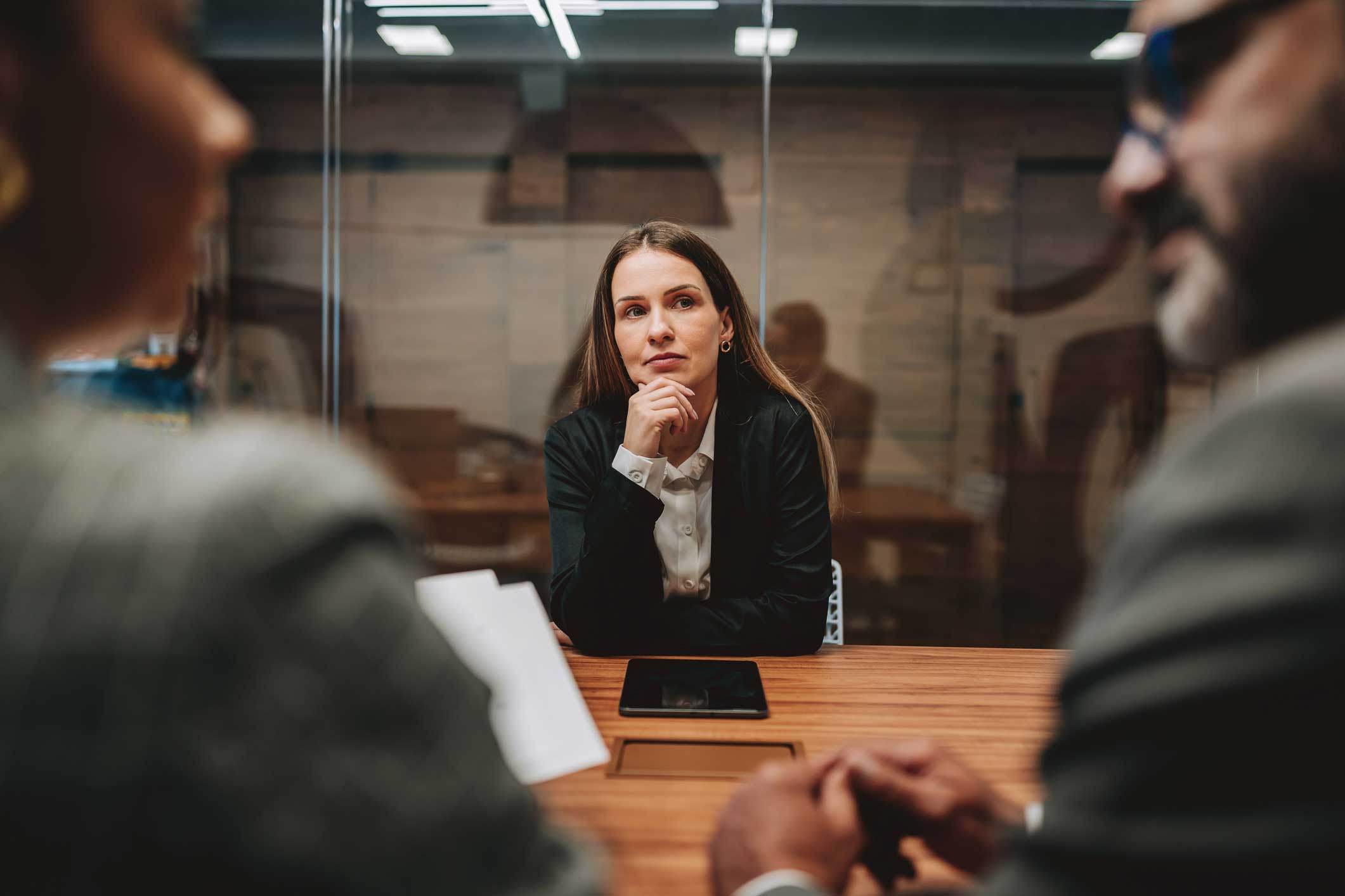 Woman sits at a table, engaged in Law Firm Financial Management Consulting Services meeting.