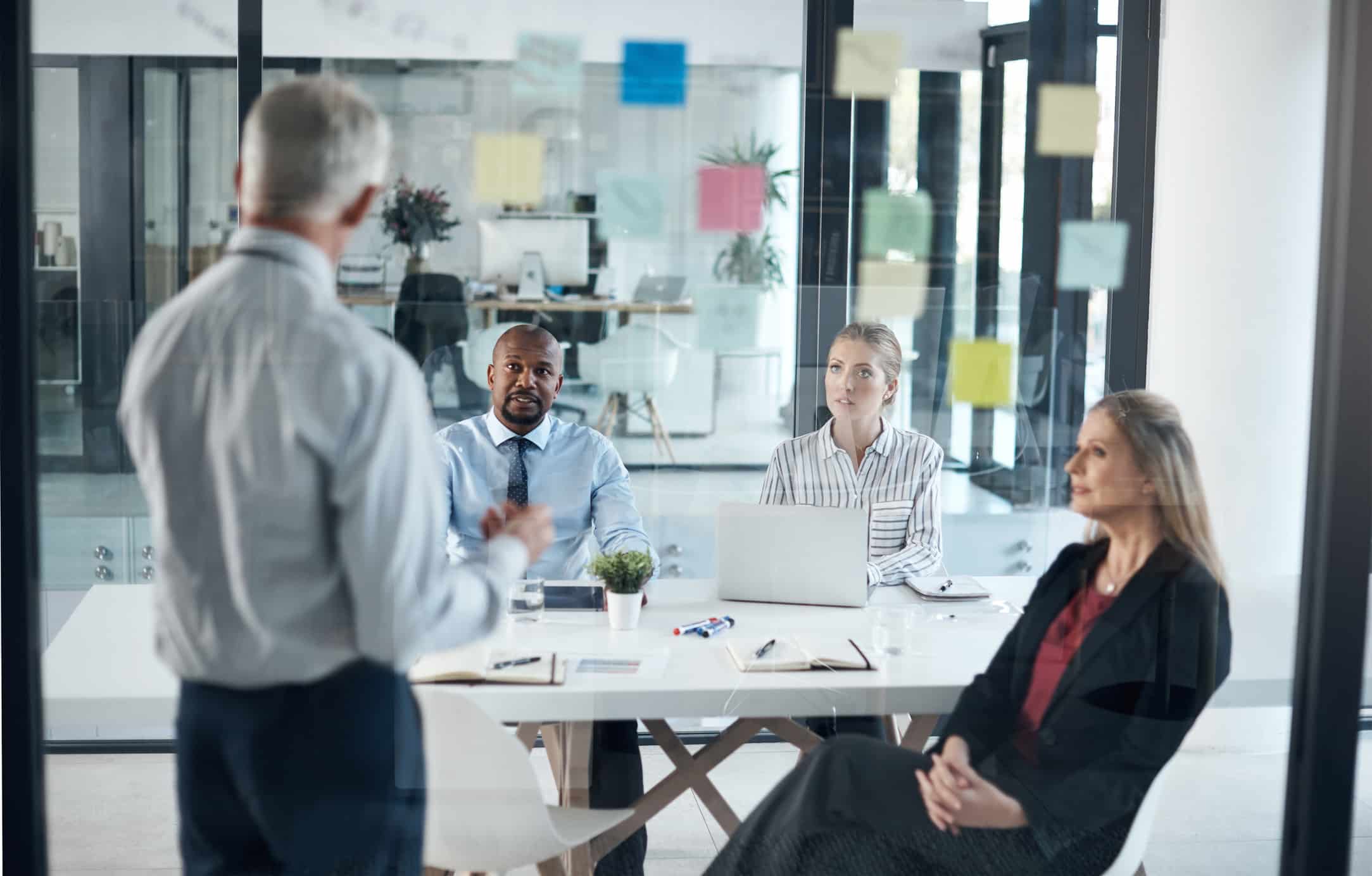 Four people in a meeting, discussing eDiscovery Data Analysis Consulting Services.