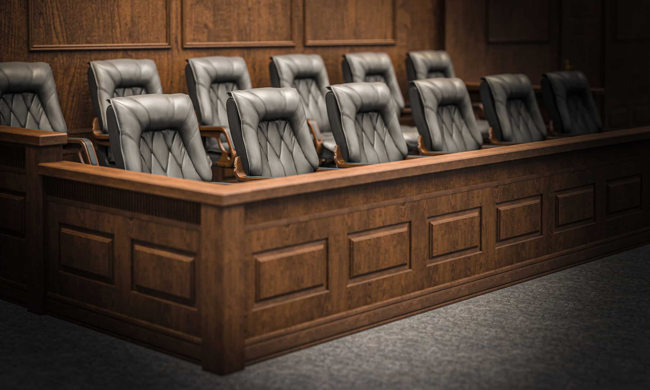 Empty jury box with black leather chairs, ideal for Witness Preparation Consulting services.