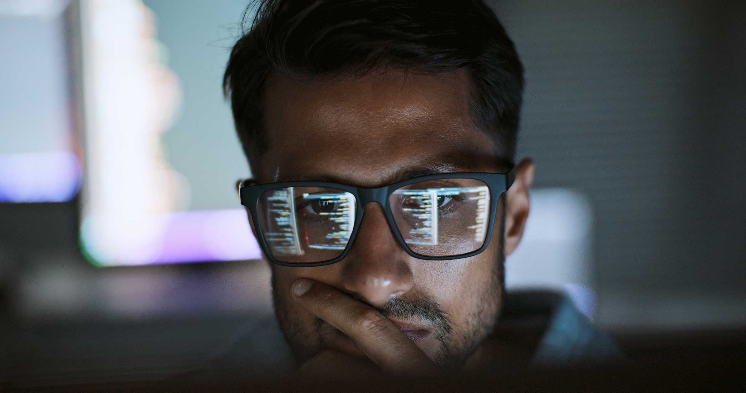 Man with glasses viewing AI Legal Document Analysis Advisory code reflected in his lenses.