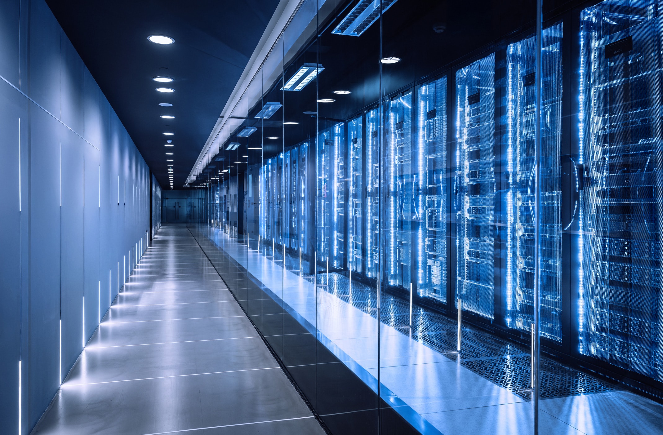 Modern server room with blue server racks, ideal for Post-Migration Support & Data Governance.