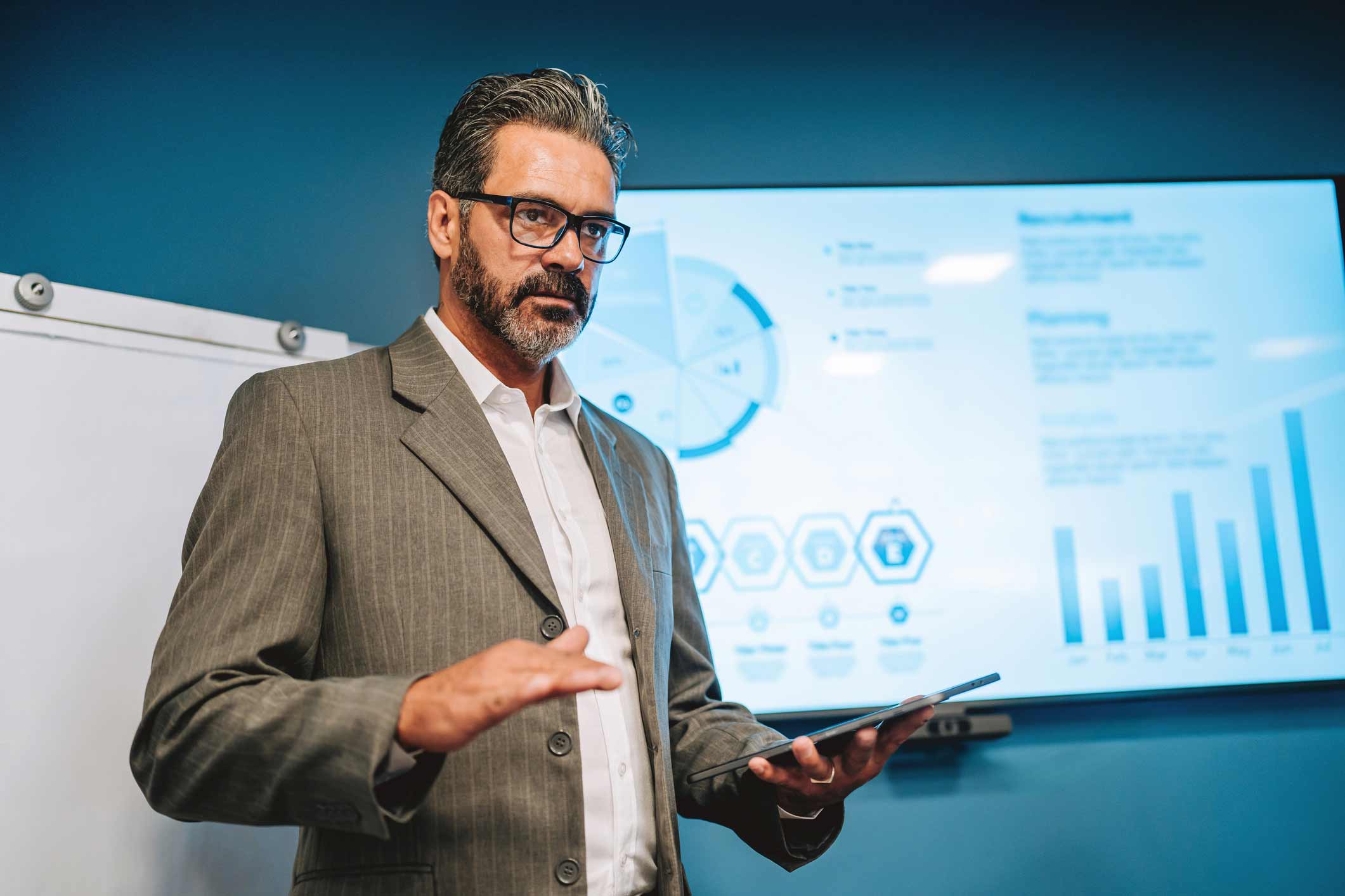 Man in suit presents data on Law Firm Expense Management in a conference room.