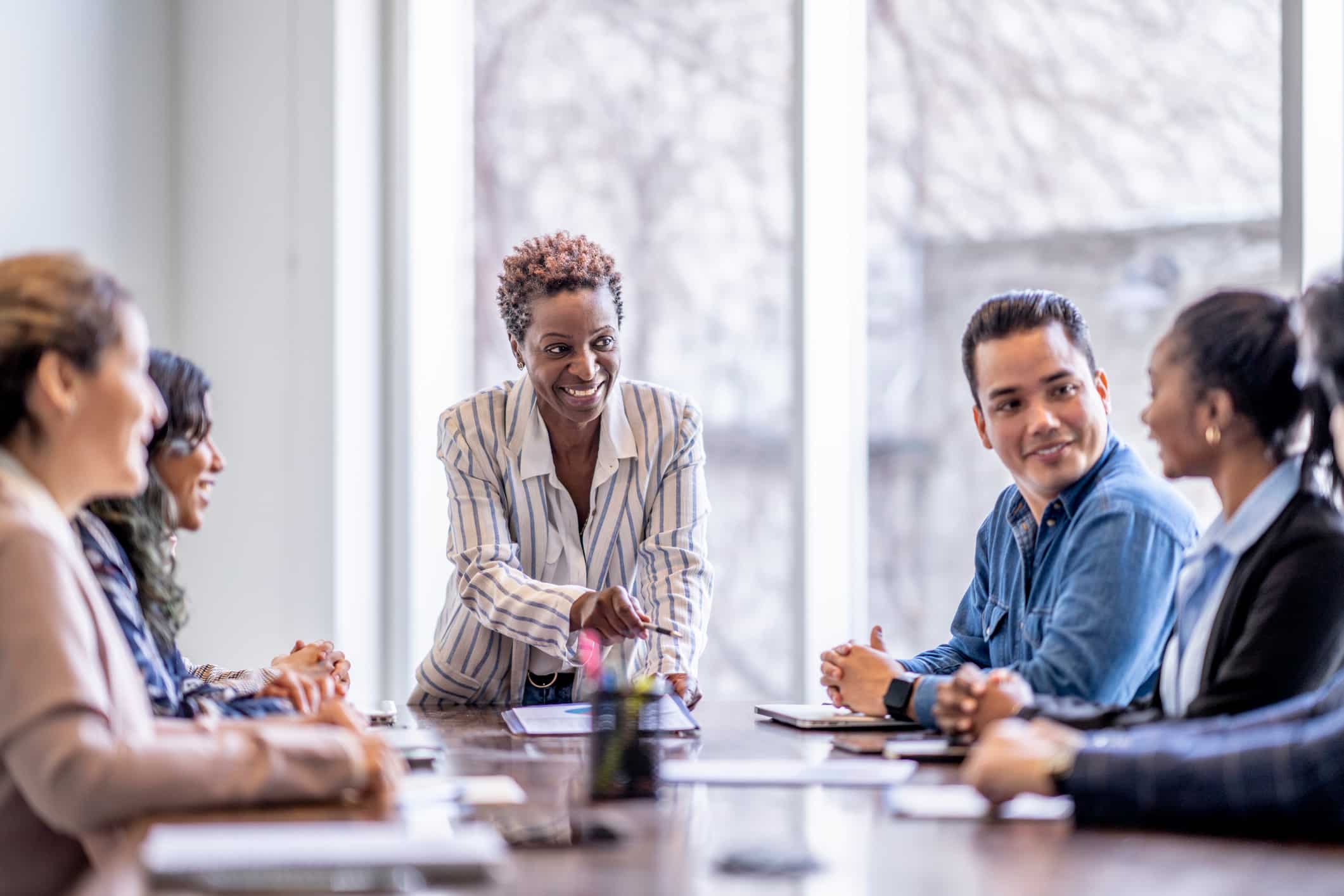 A woman leads an eDiscovery Data Management Planning meeting in a bright, modern office.