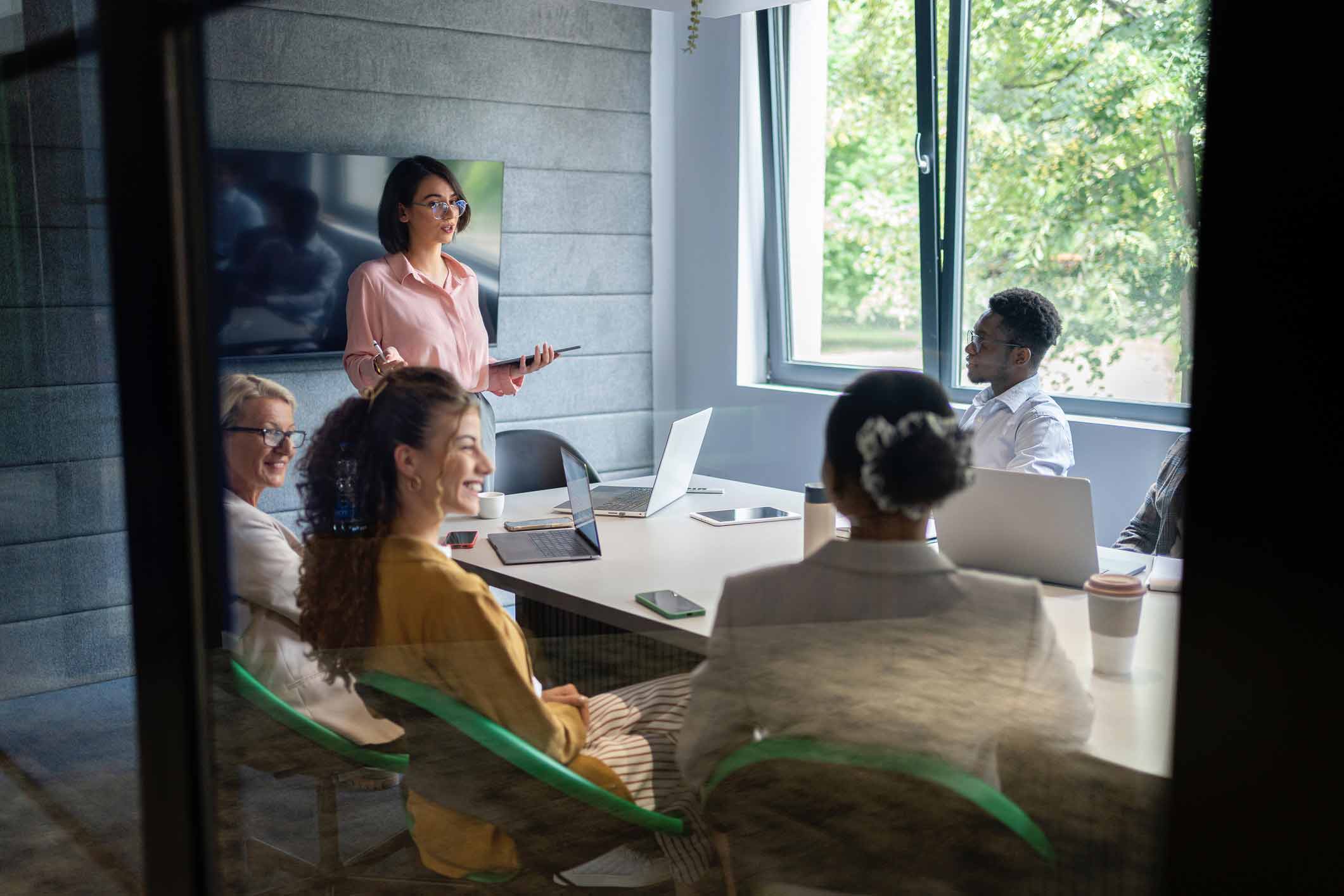 Woman presenting Law Firm Financial Management Enablement to colleagues in a modern office.