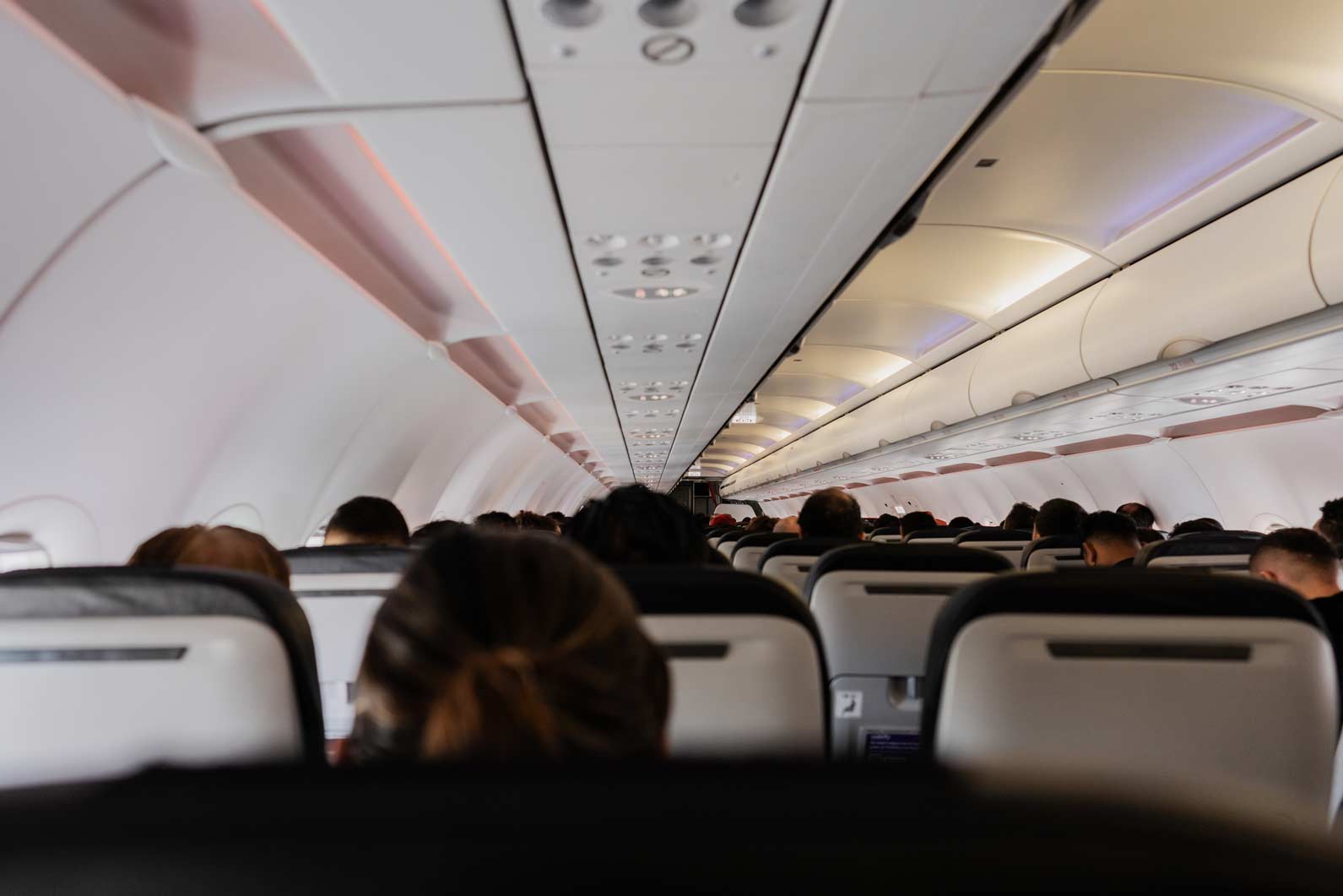 Passengers seated inside an airplane, with AI-Driven Airline Load Factor Optimization at work.