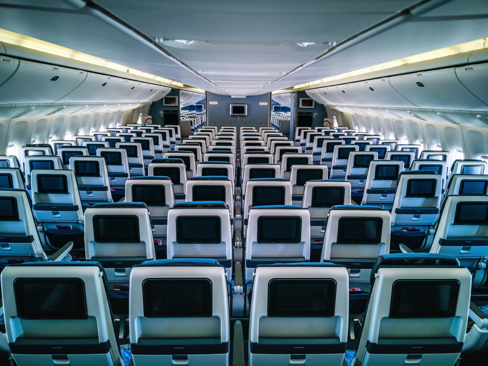 Empty airplane cabin with rows of seats, ideal for AI-Driven Load Factor Optimization for Airlines.