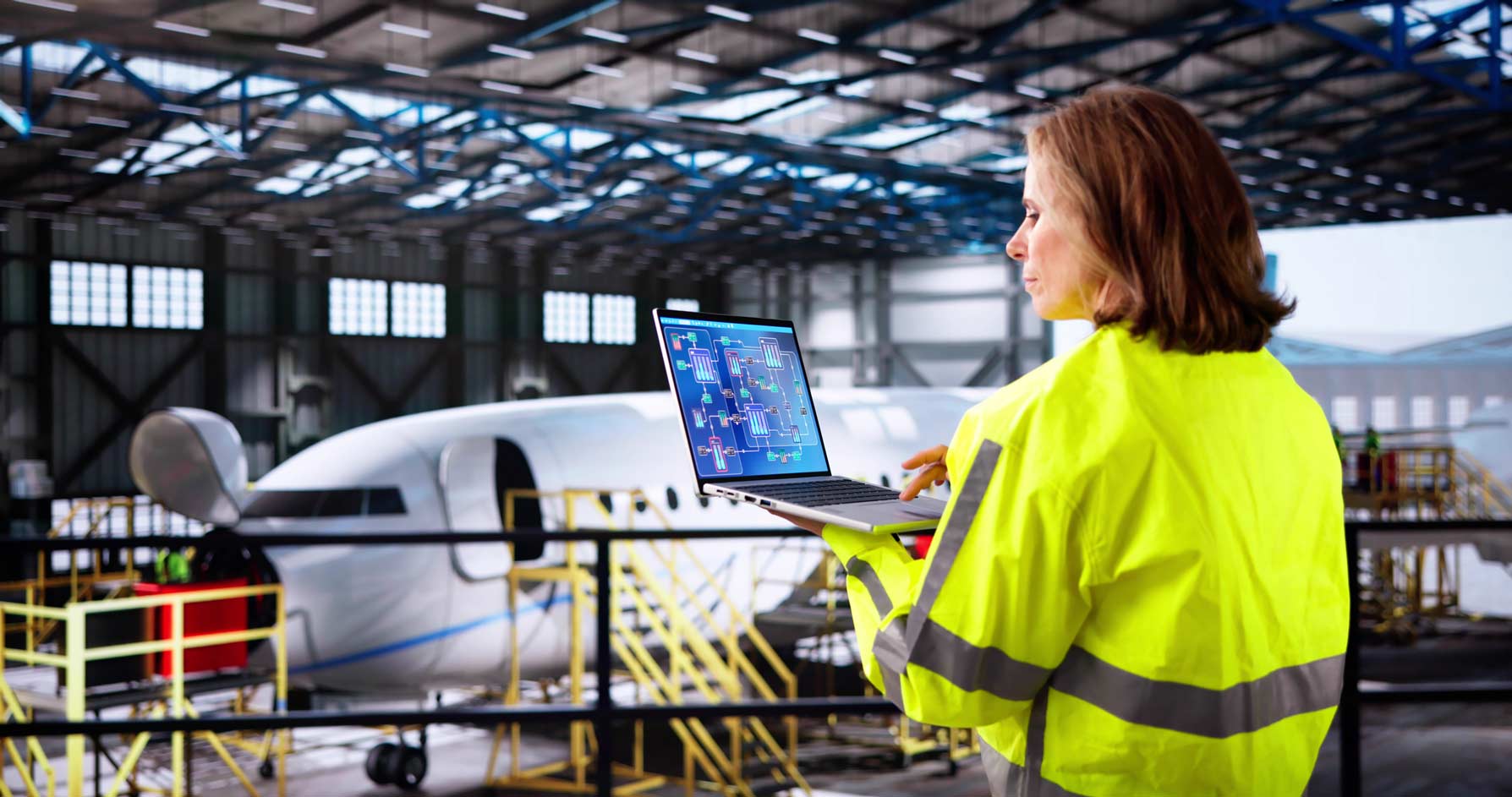 Woman in hi-vis jacket uses laptop for AI Predictive Maintenance near aircraft under repair.