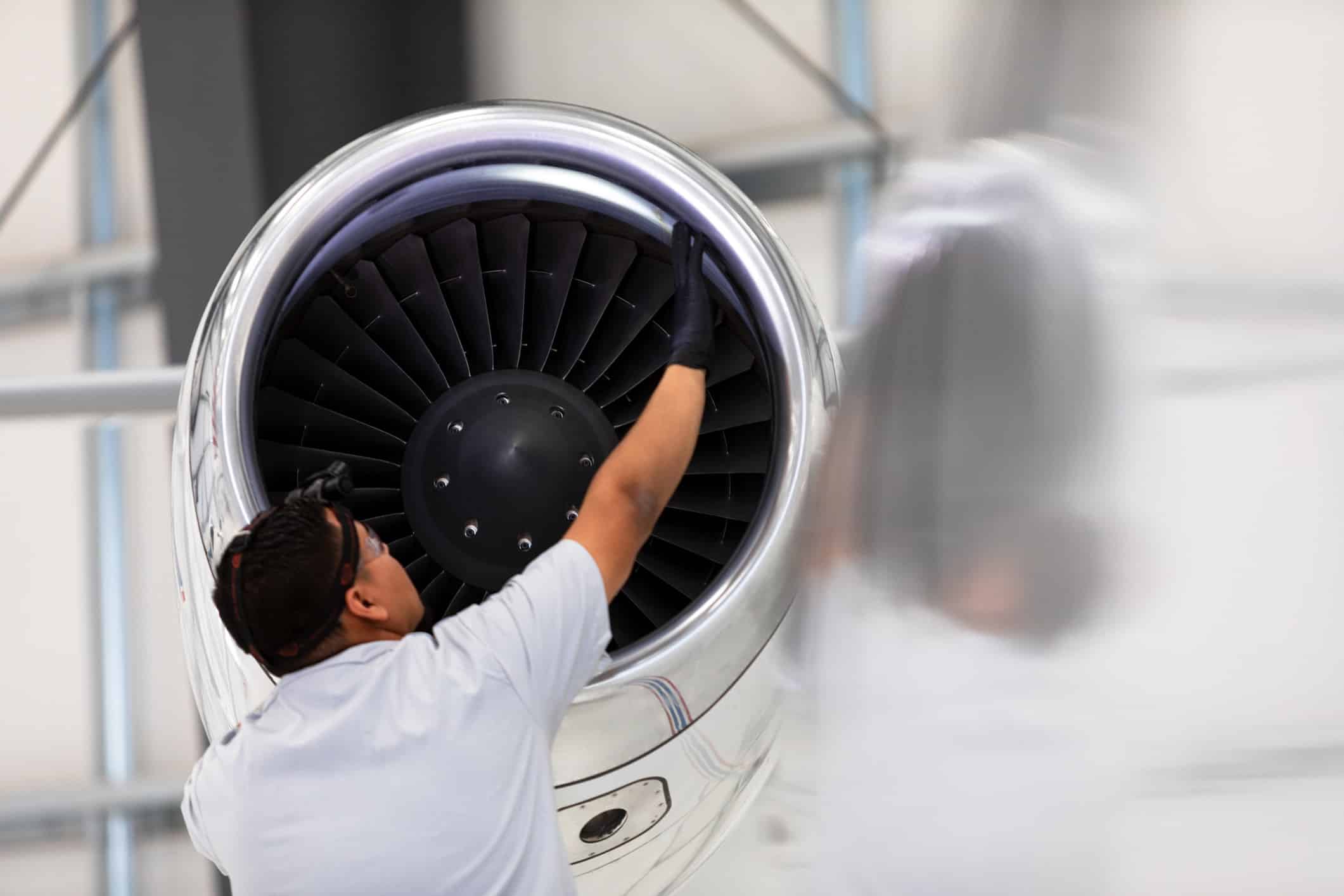 A technician inspects a jet engine turbine, supporting airline crew productivity and efficiency.
