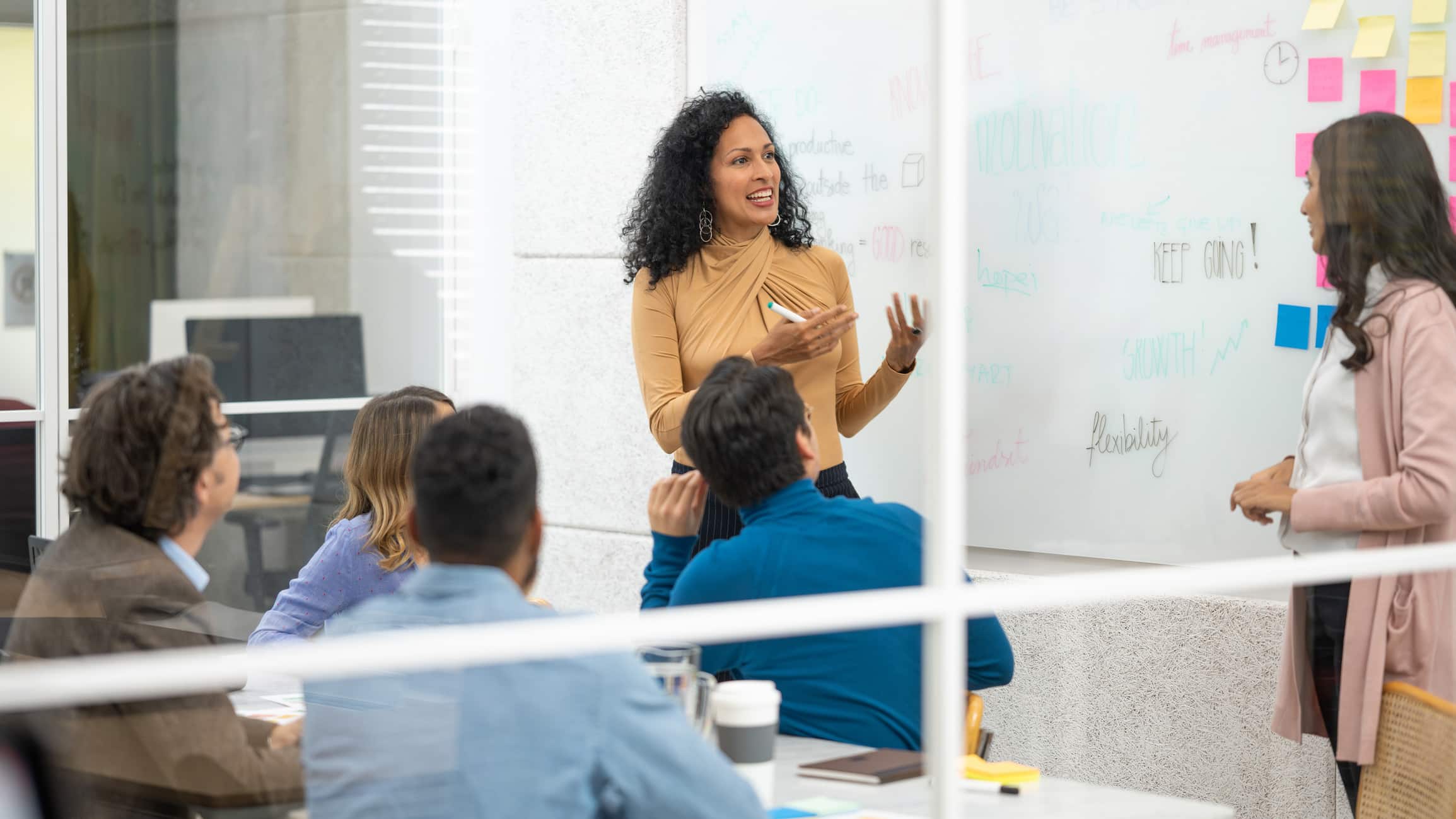 Woman presenting to colleagues on Airline Organizational Culture Transformation Consulting.