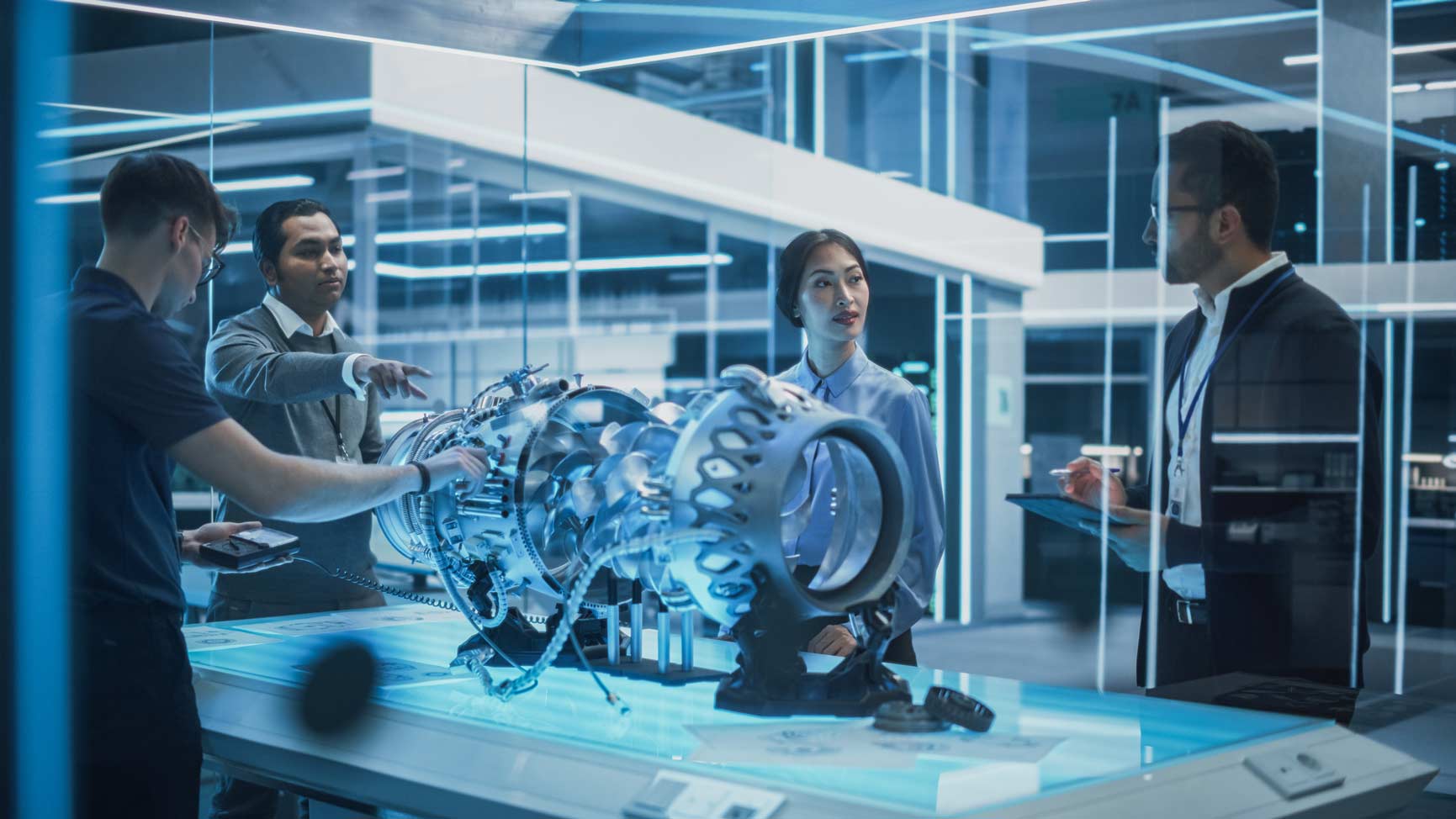 Four professionals discuss Aviation IT Governance & Risk Management in a modern lab setting.