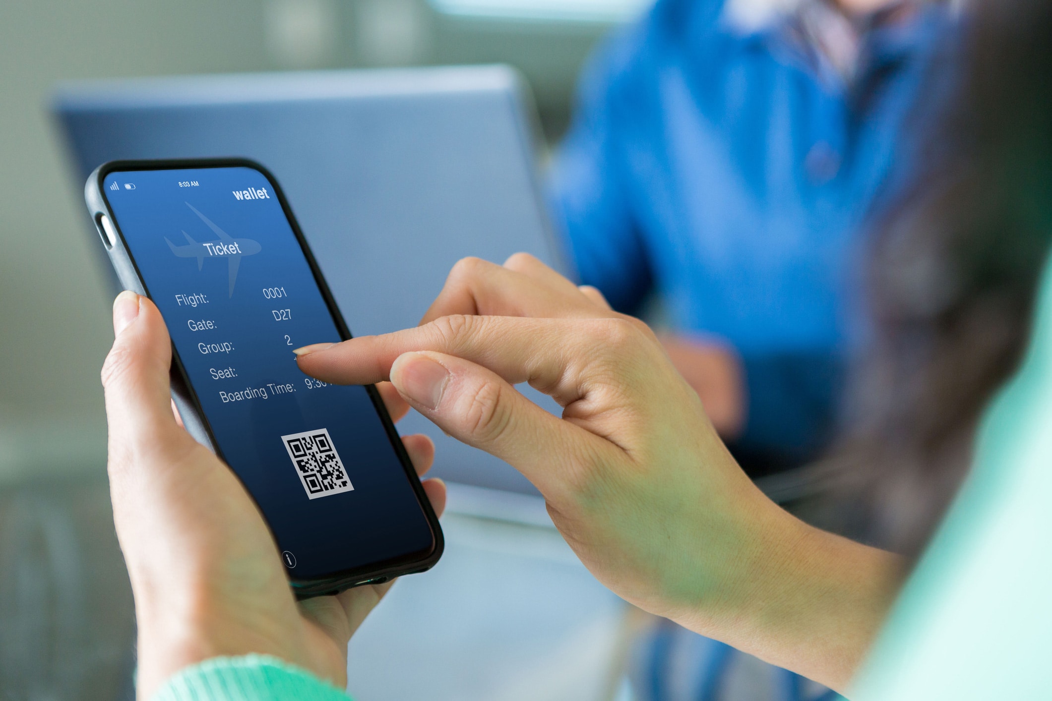 Person holding a smartphone with a digital boarding pass from Cloud-Based Booking Systems.