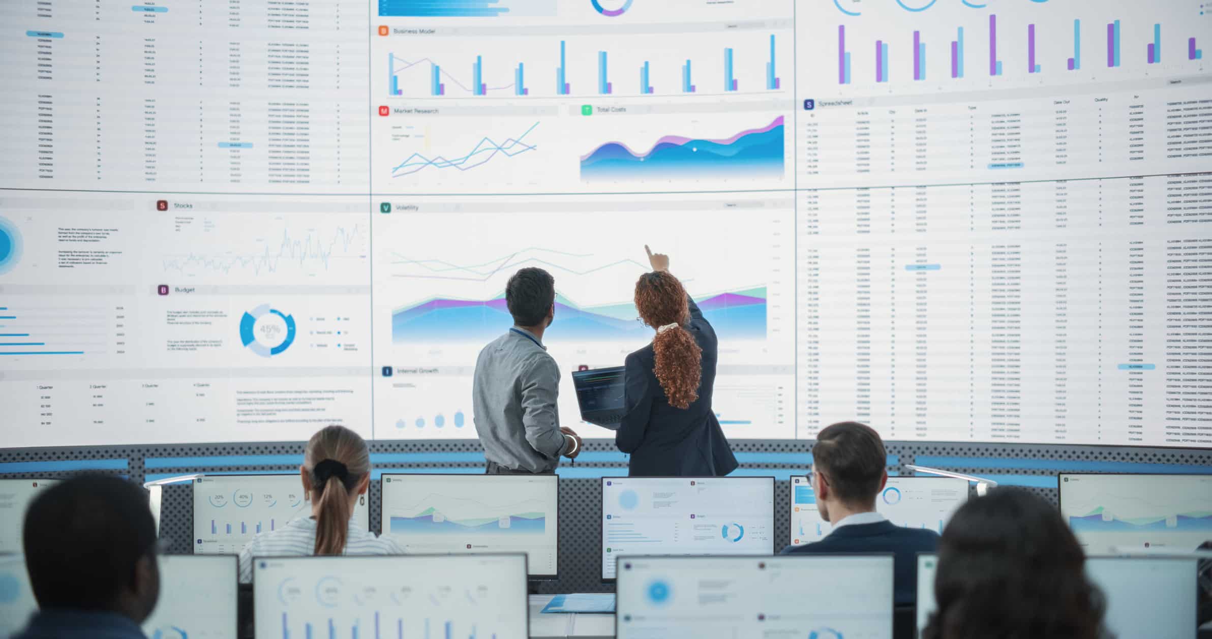People analyzing data graphs for Hospitality Enterprise Application Implementation Consulting.