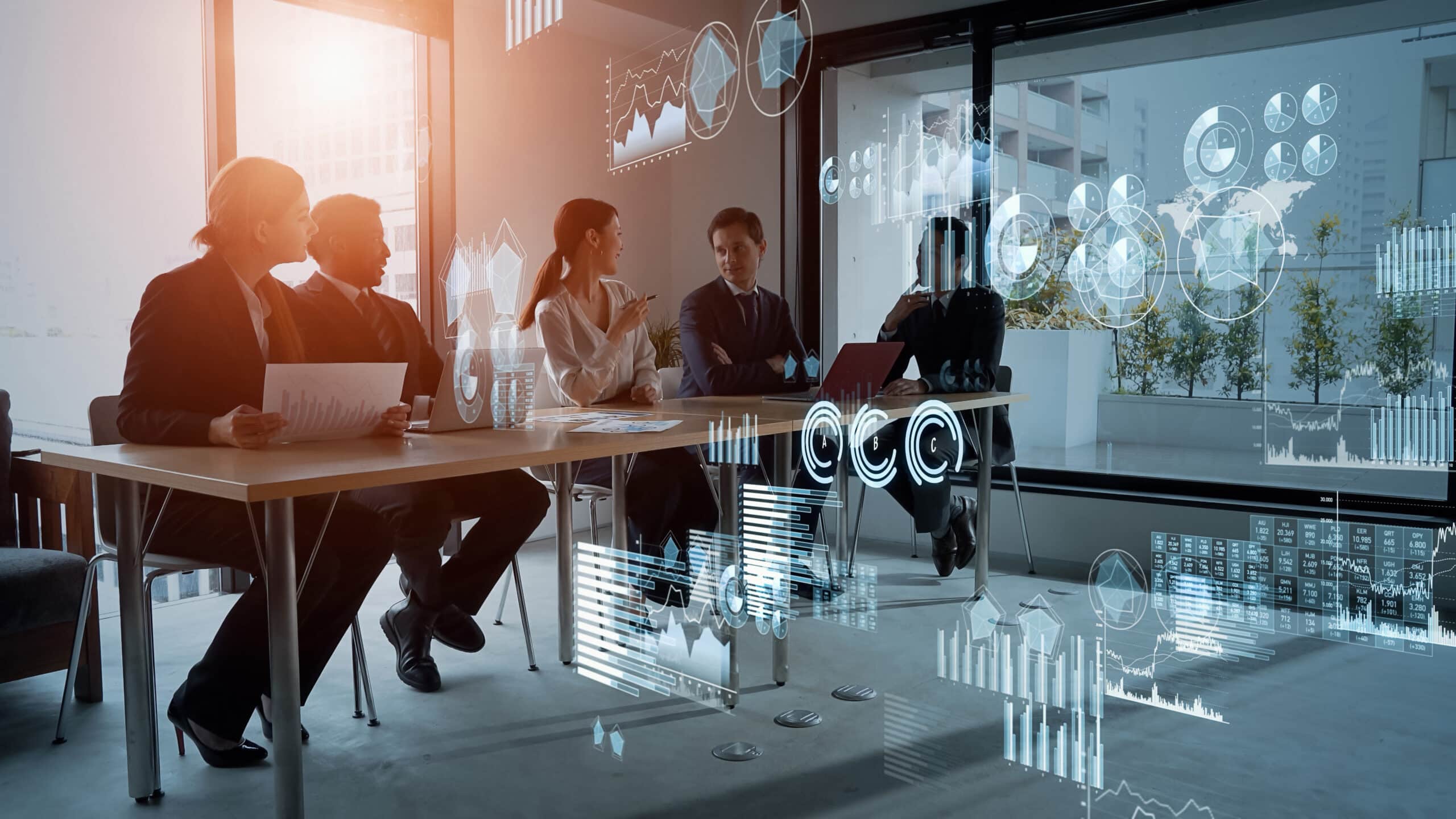 Four businesspeople discuss NDC Integration and revenue optimization with digital charts overlaid.