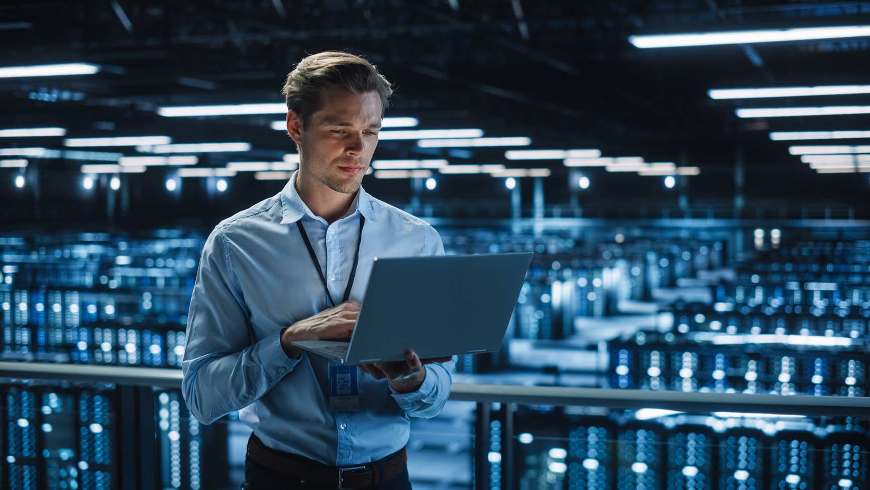 Man in a data center managing infrastructure for blockchain payments amid blue-lit server racks.