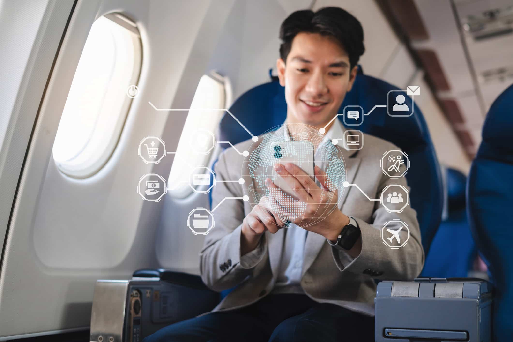Man using smartphone on airplane, exploring omnichannel strategies with digital interface icons.