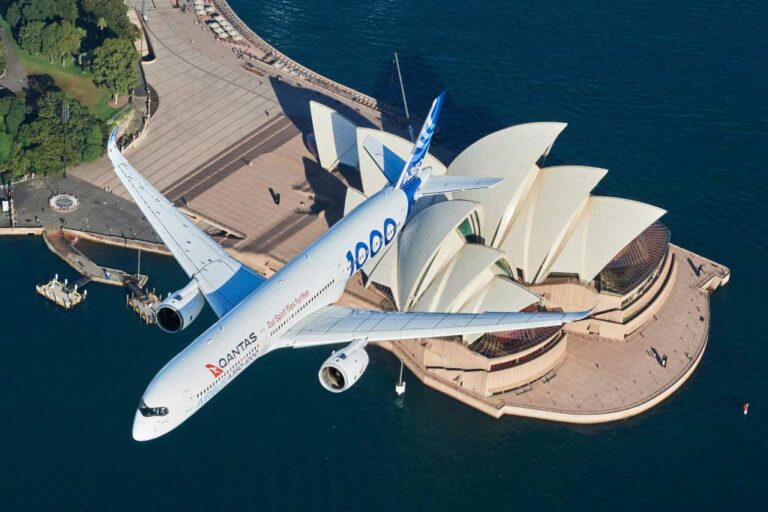 Airplane soaring over the Sydney Opera House, showcasing aviation strategy innovation consulting.