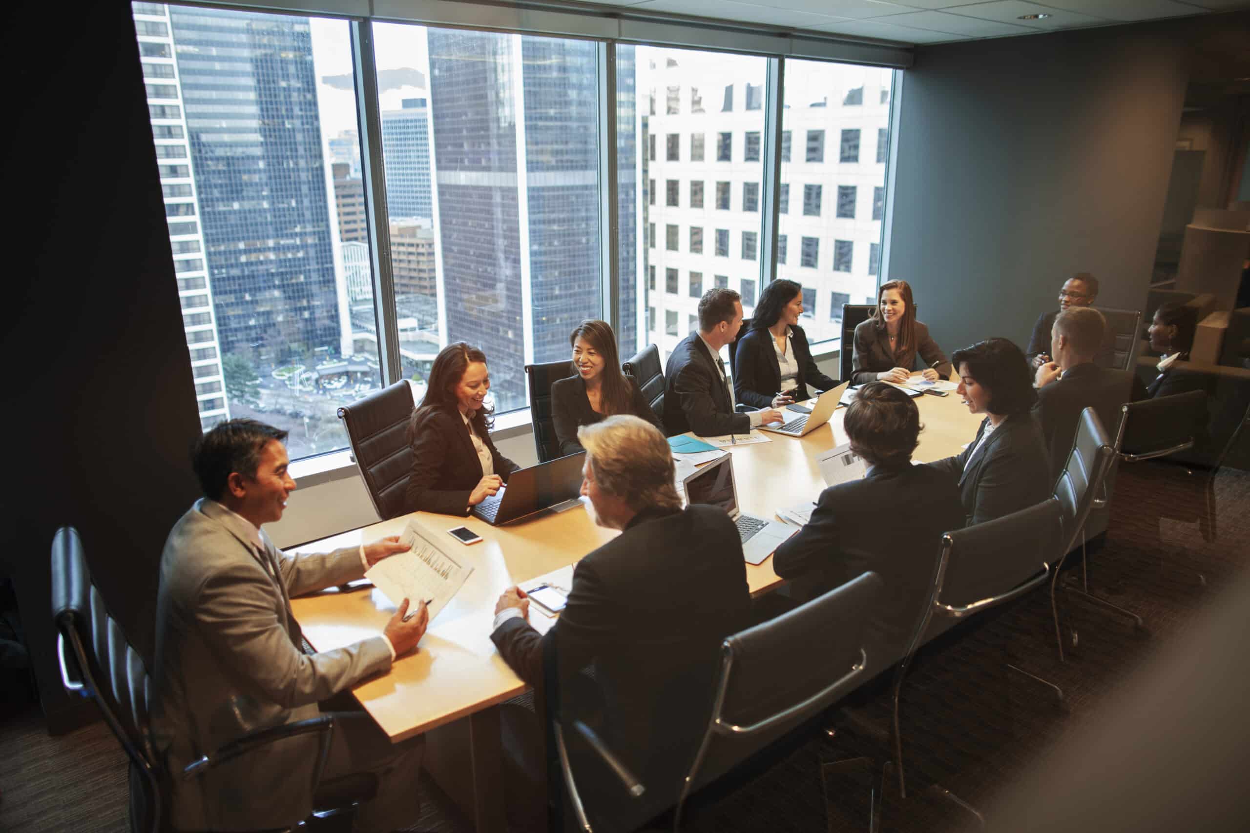 A group discusses commercial real estate operations around a conference table in a modern office.