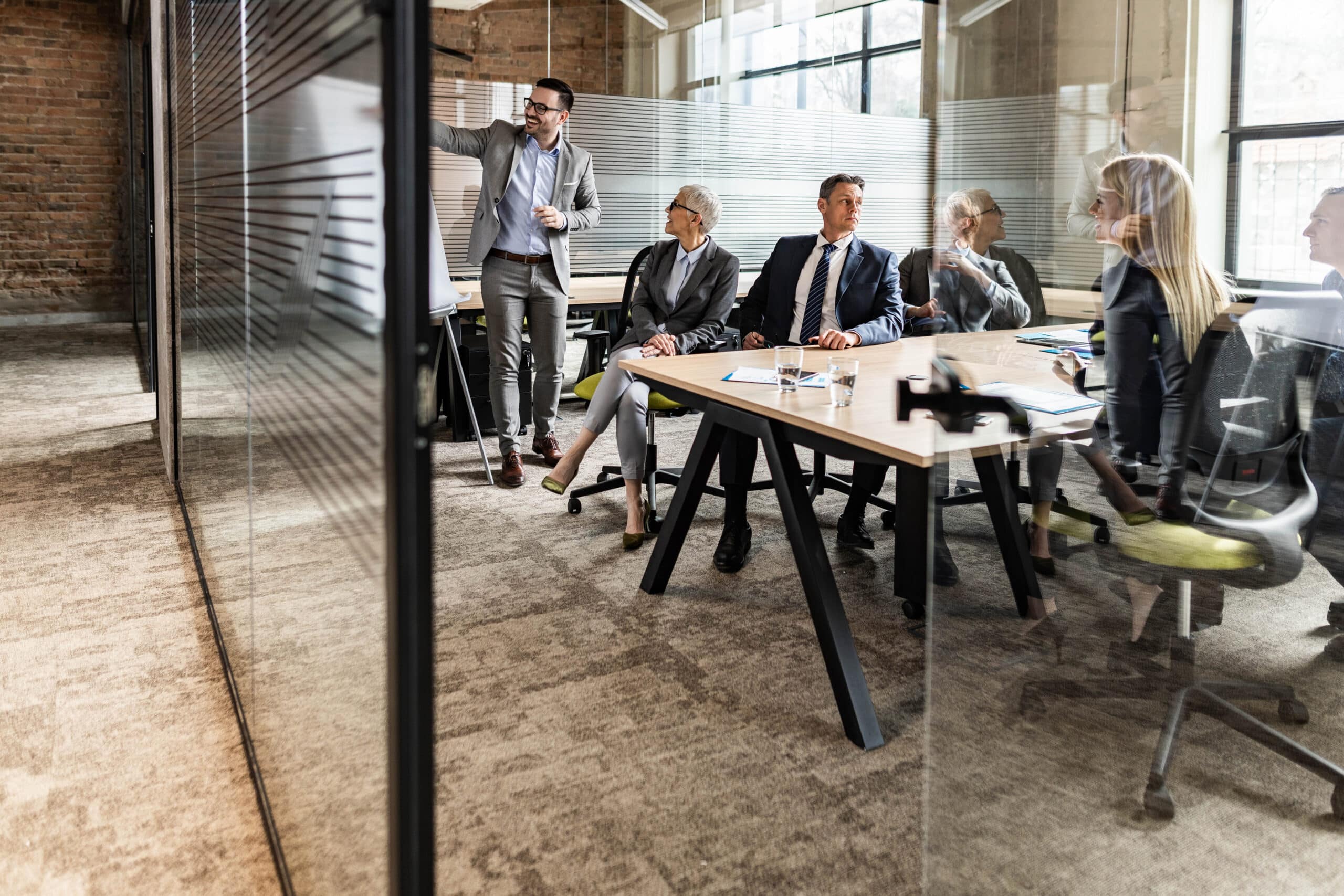 Business meeting in a modern office; intelligent automation consultants presenting to colleagues.
