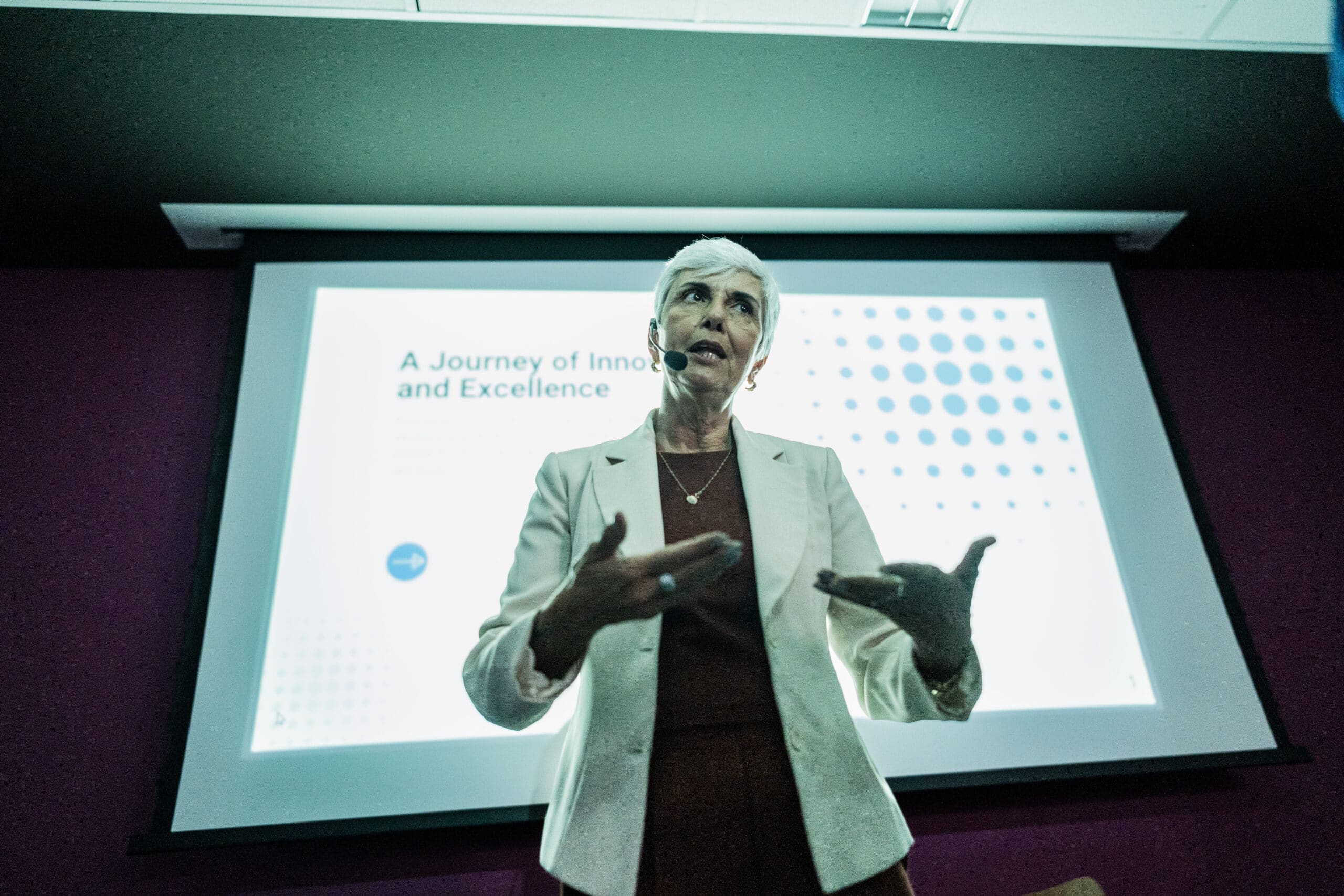 Woman presents "A Journey of Innovation and Excellence" on land use planning consulting.