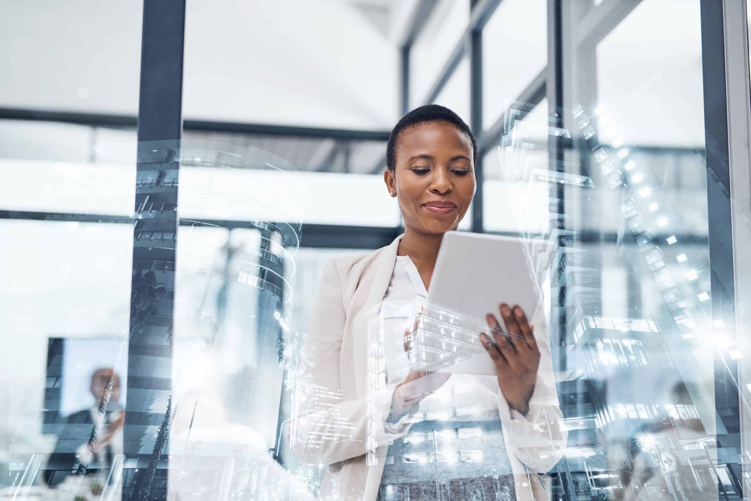 Businesswoman using a tablet in a modern office, reflecting leadership development consulting.