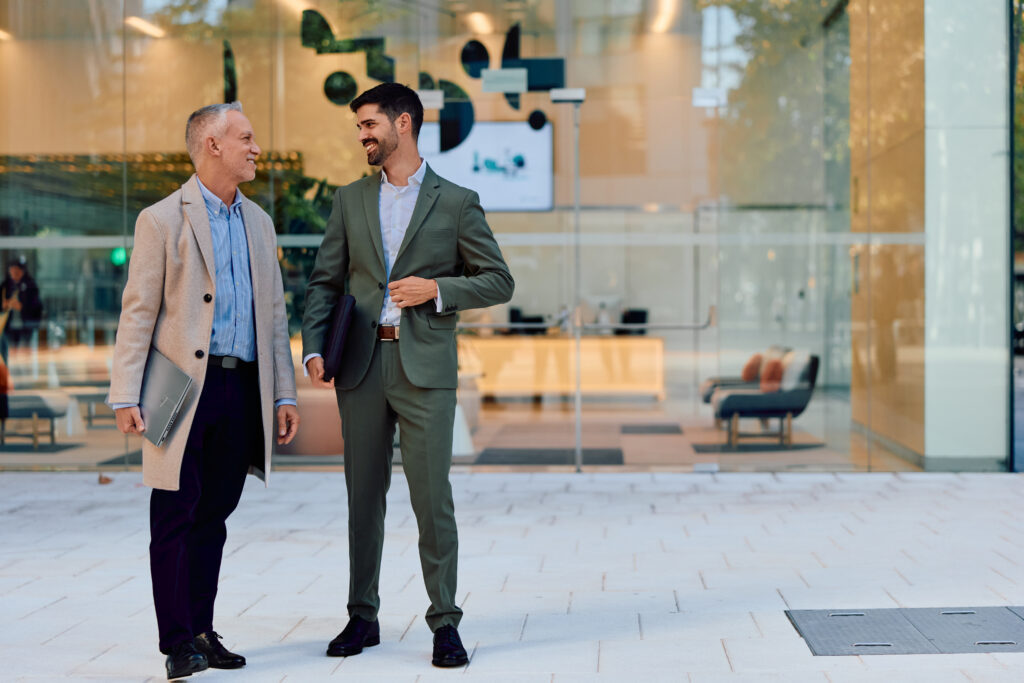 Two commercial real estate operations consultants smiling