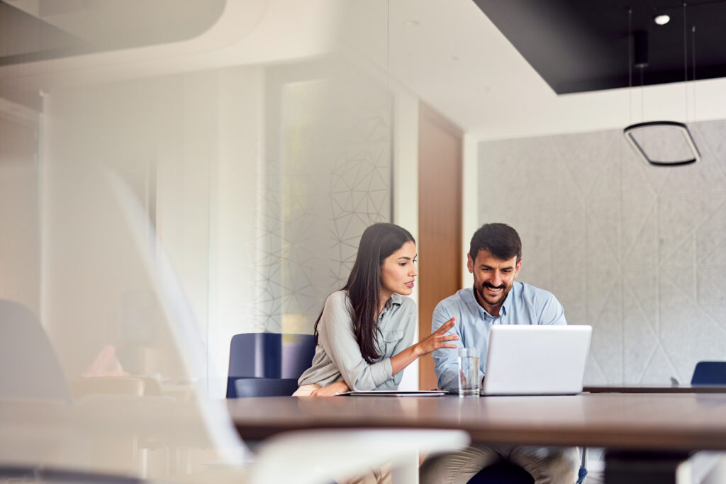 Two Young Businesspeople Working on commercial real estate tax management consulting