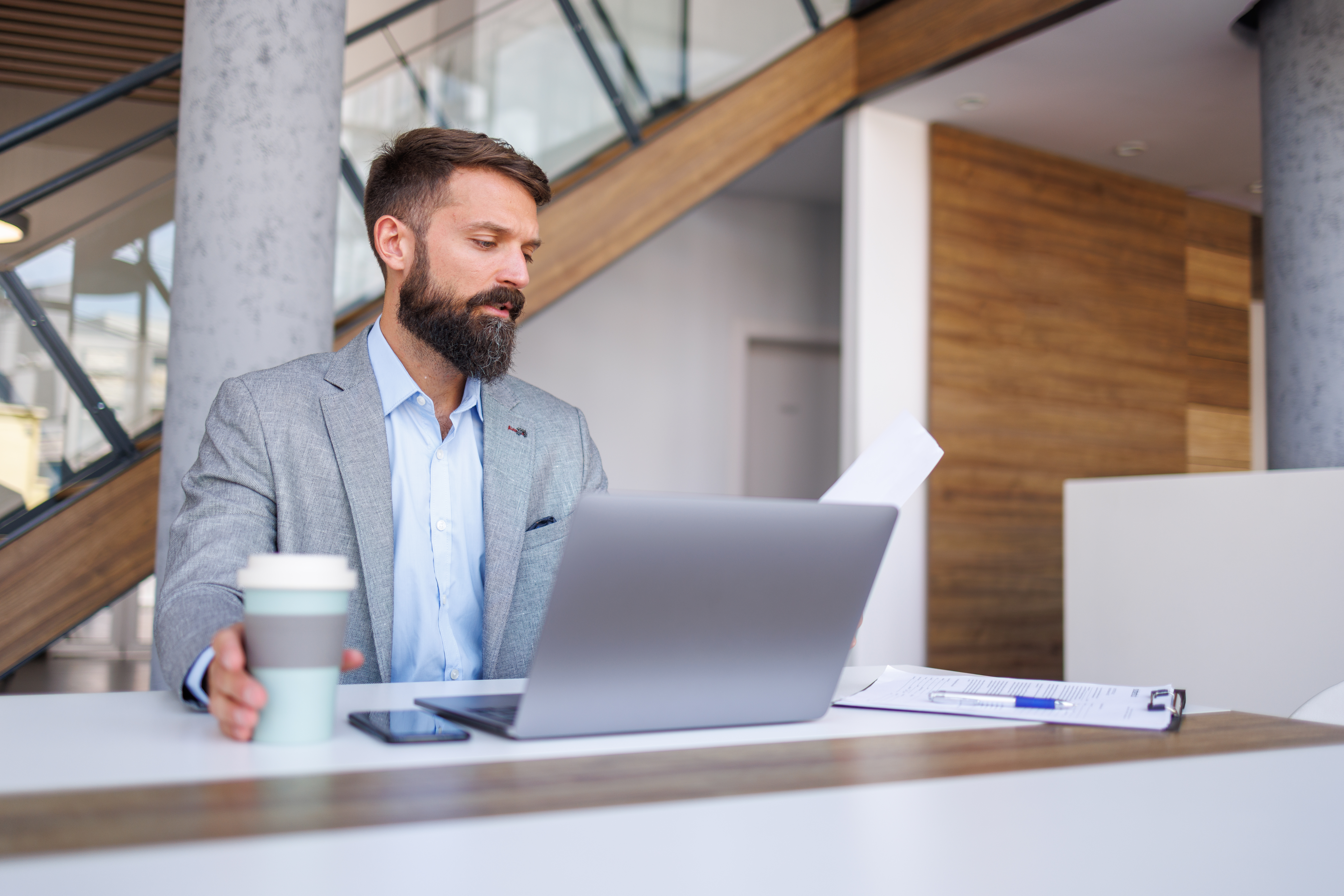 Businessman working on laptop in modern office