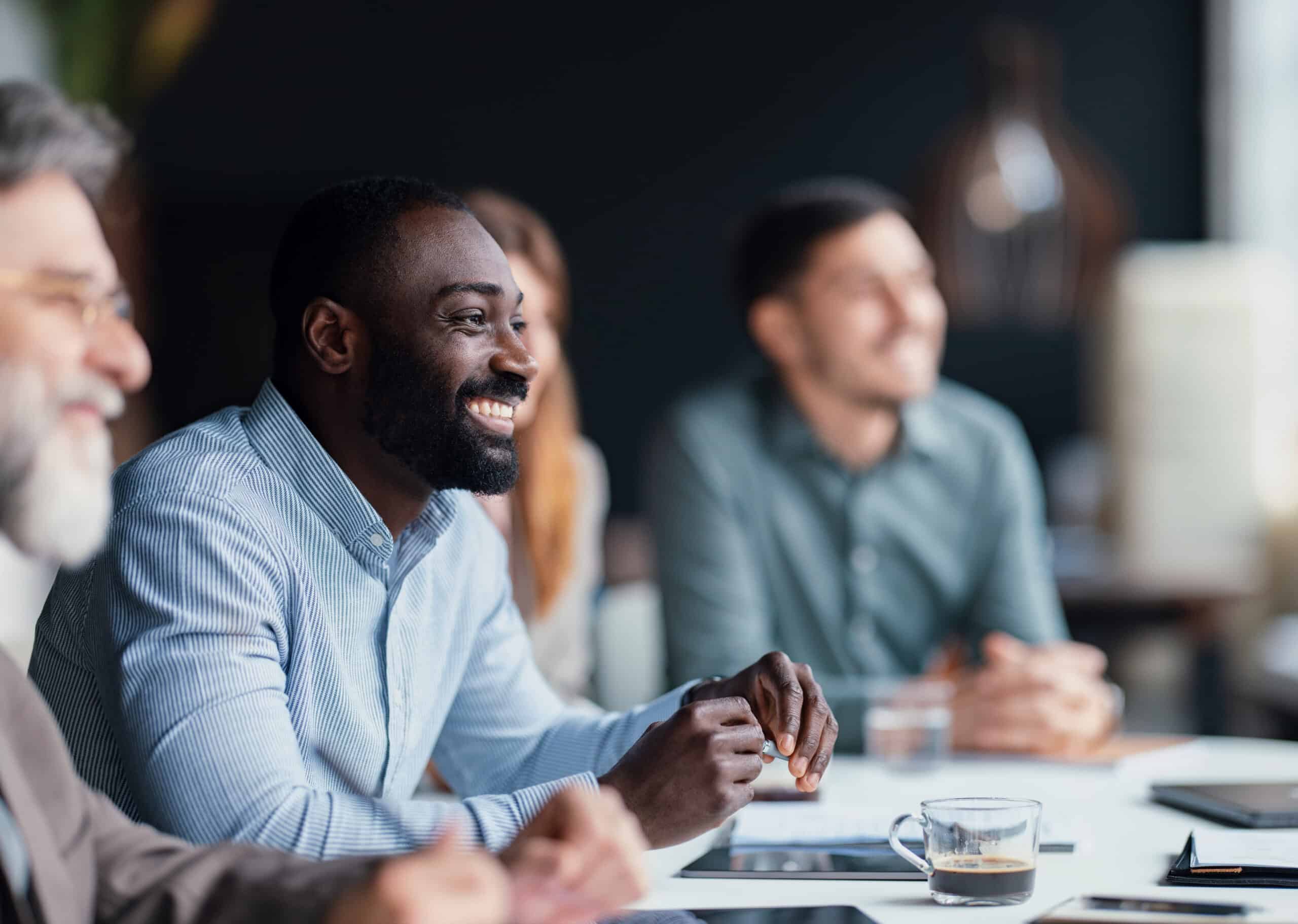 Smiling Professionals Collaborating During a Productive Business Meeting in a Modern Office