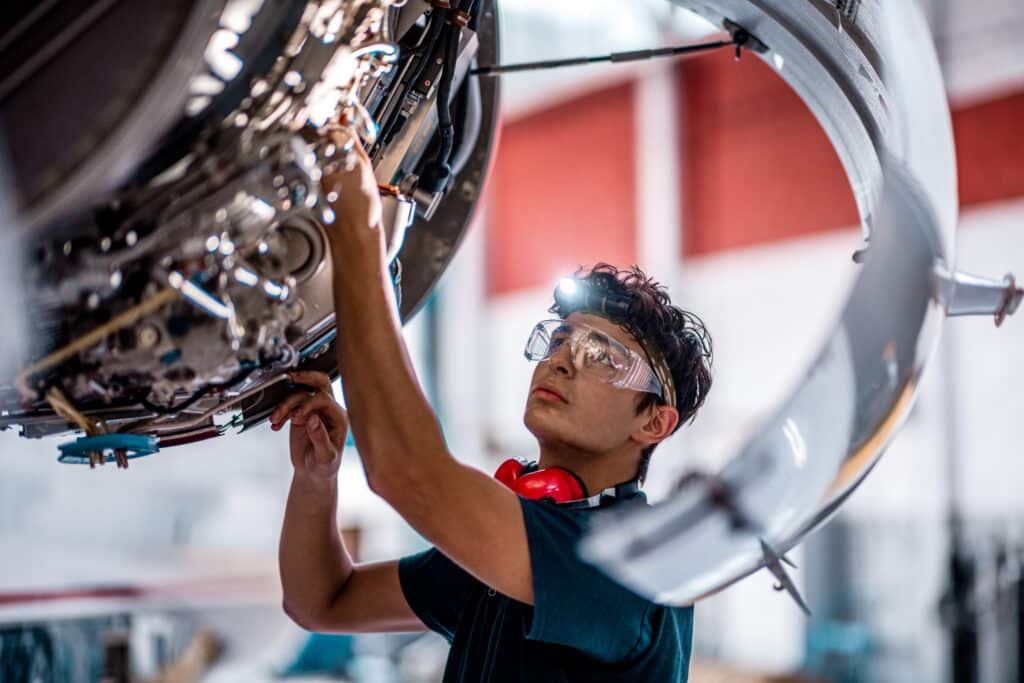 Aircraft Mechanic checking jet engine symbolizing AI and the Rise of the Autonomous Airline