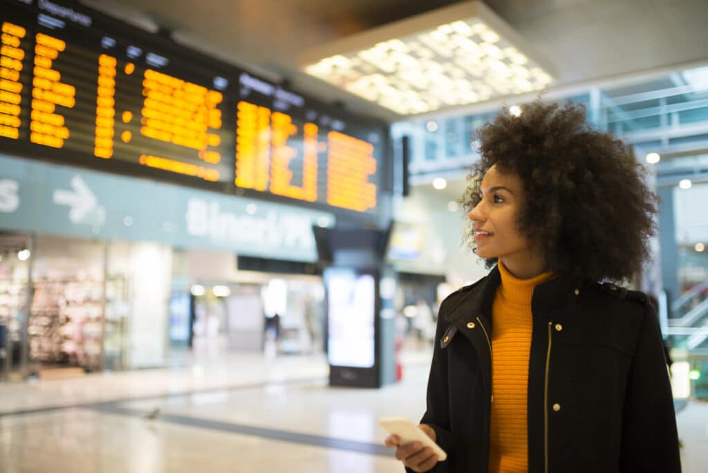 Woman at the train station checking the departure board