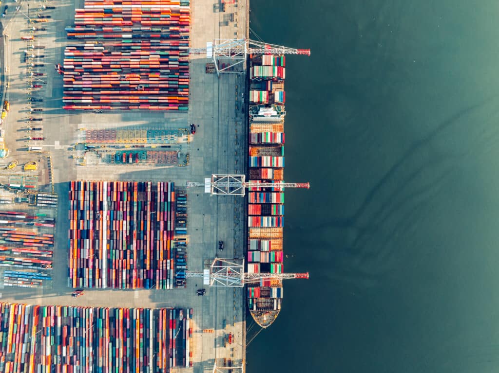 Cargo ship loading containers at southampton port terminal