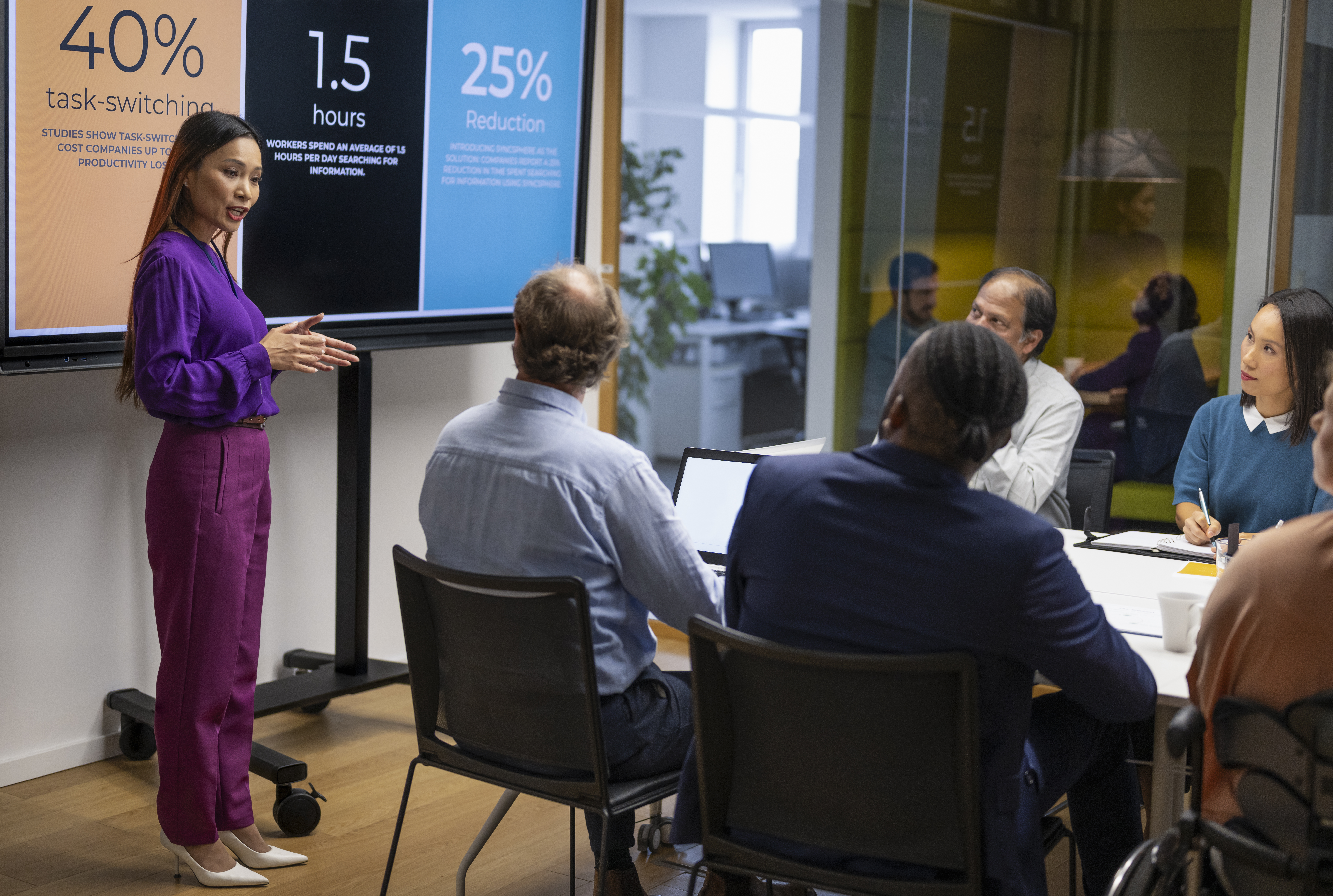 Female presenter interacting with the audience at a business presentation representing cost transformation consulting