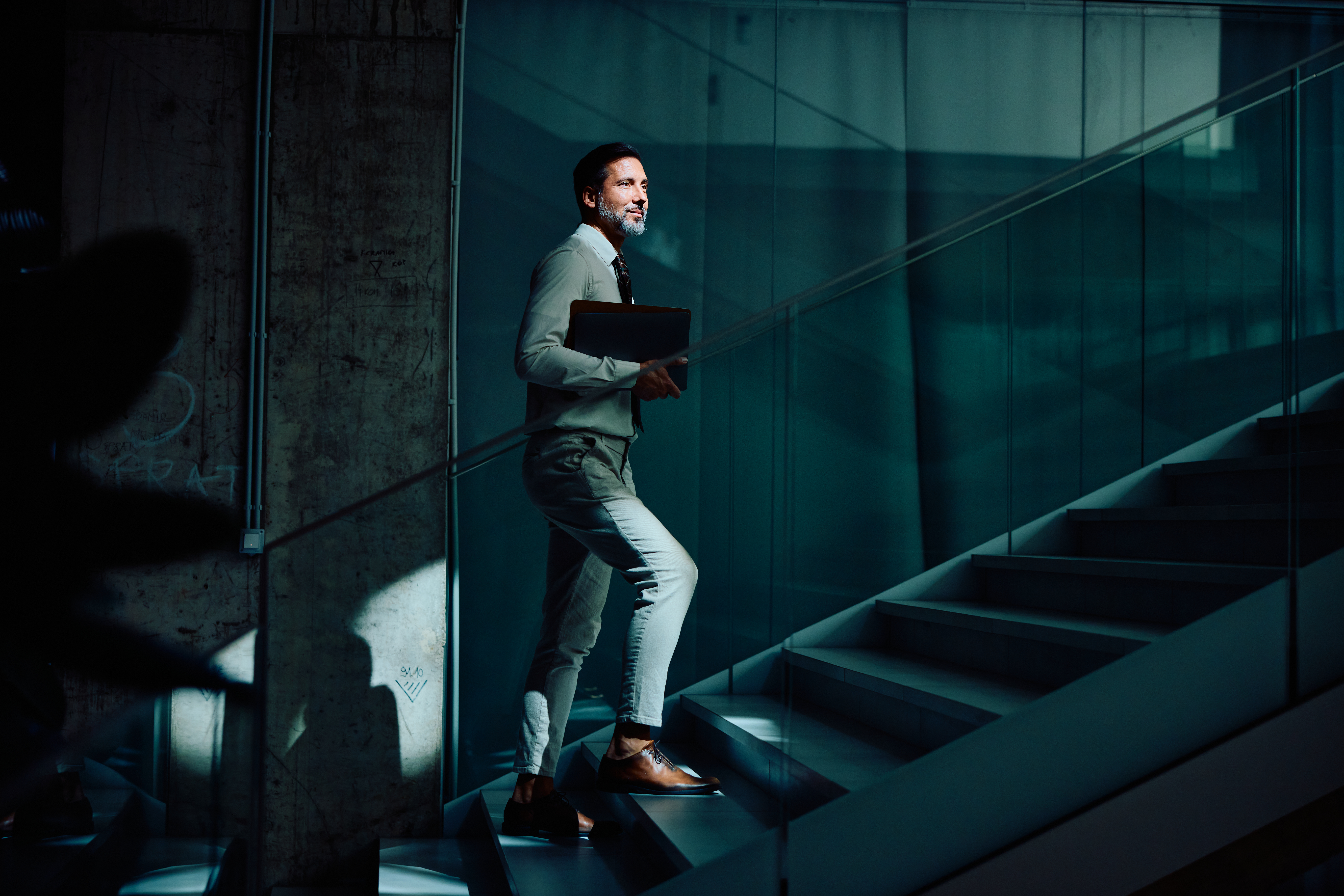 Businessman carrying a laptop representing digital marketplace consulting