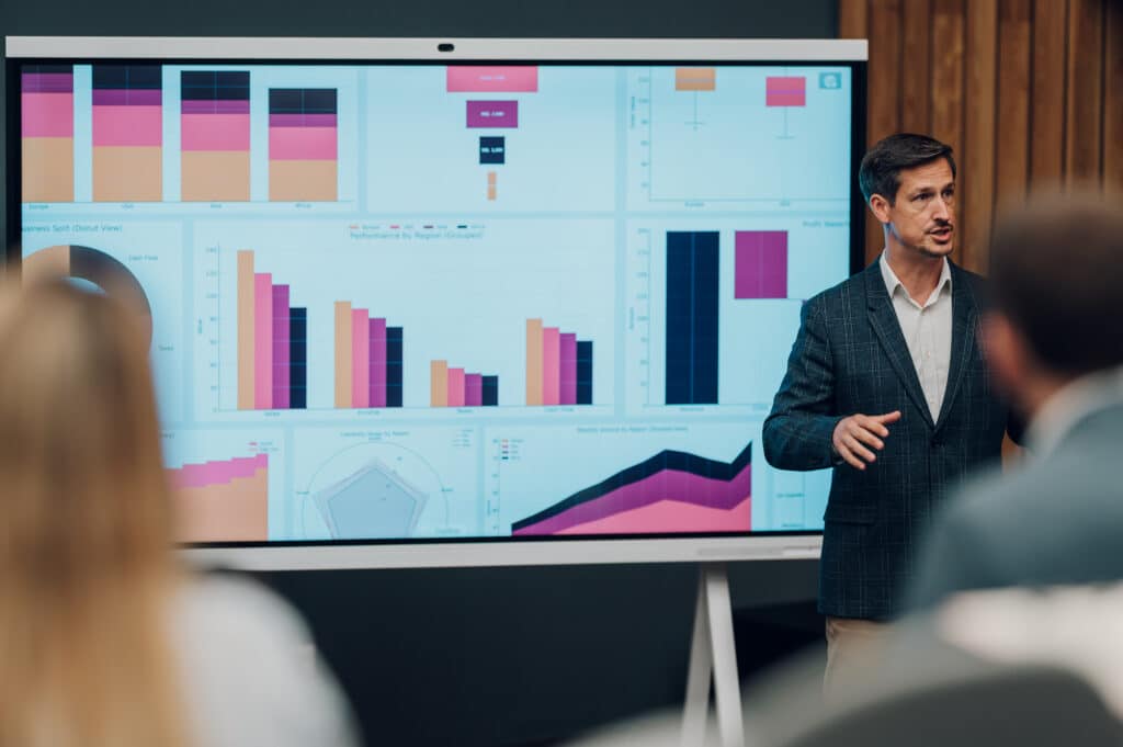 Man presenting data charts to represent go to market strategy consulting