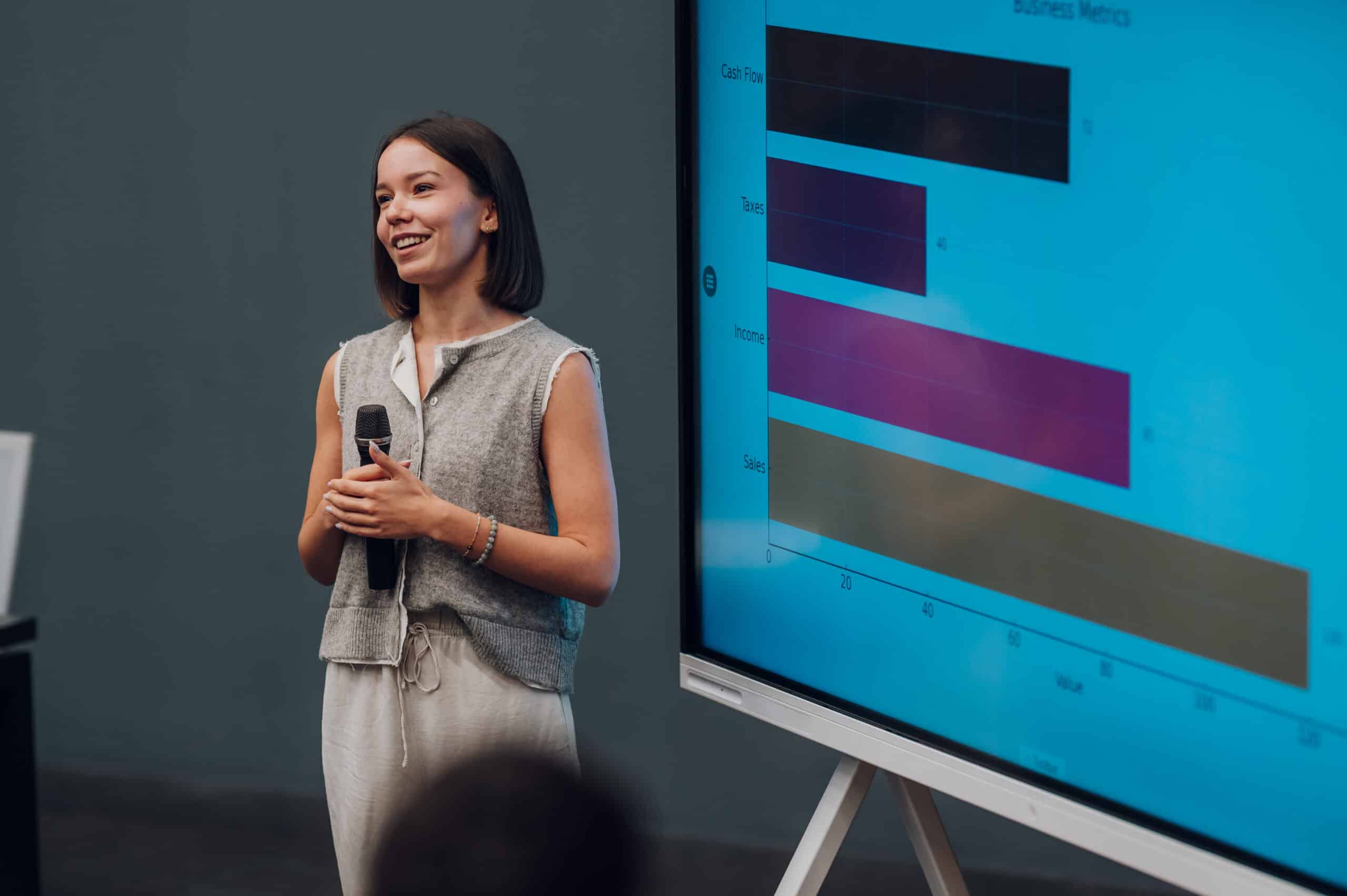Woman speaker giving business presentation representing pricing strategy consulting