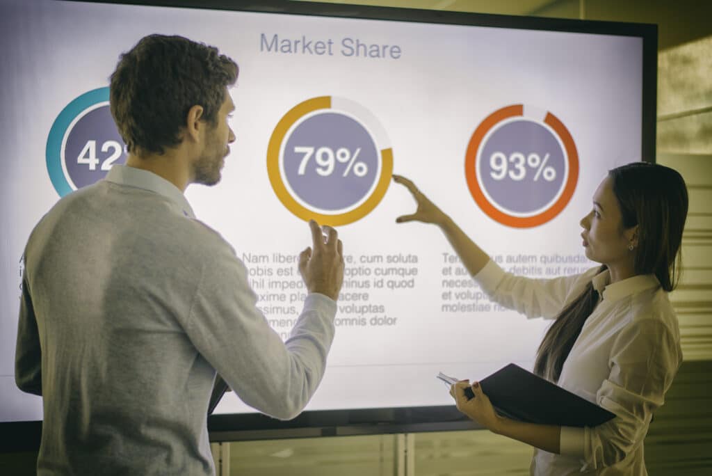Businesswoman and businessman talking representing revenue growth consulting